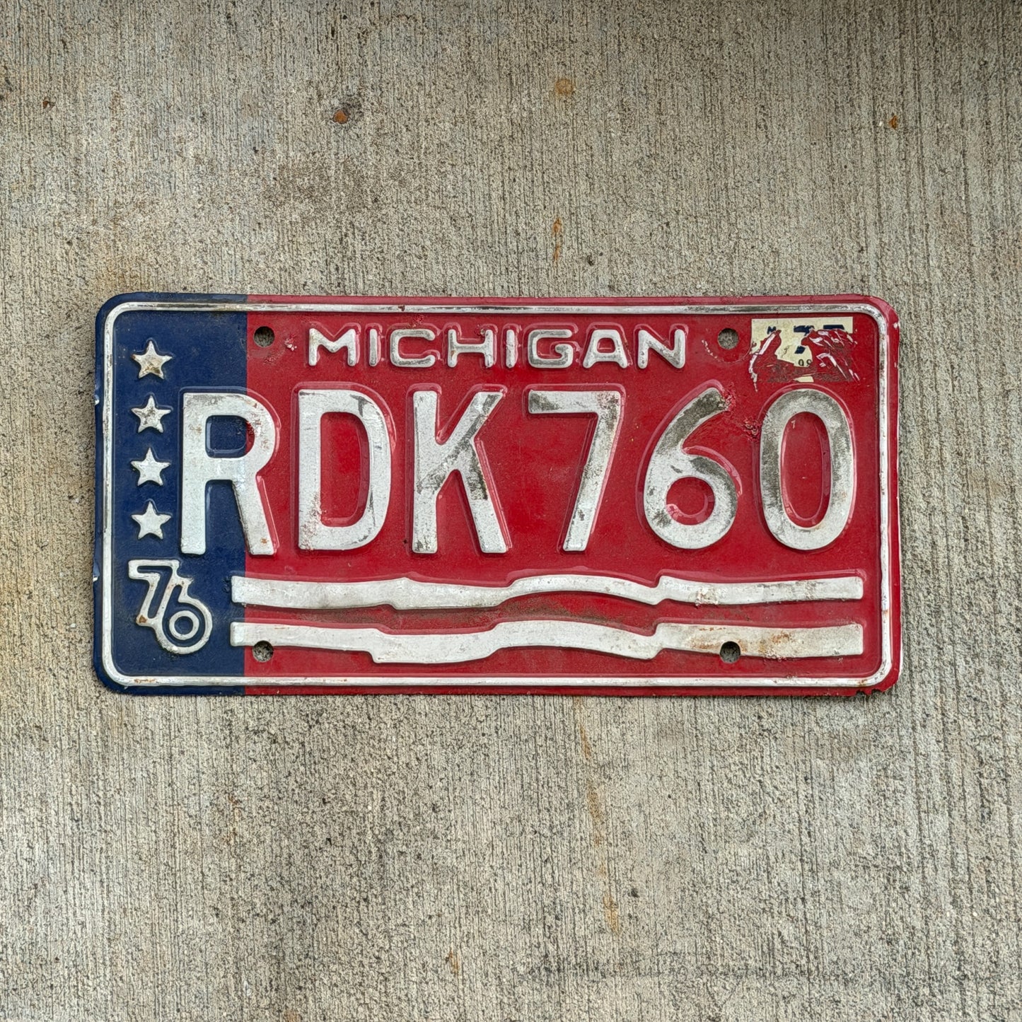Photo of a 1976 Michigan License Plate Auto Tag Garage Decor Vintage Bicentennial RDK 760 with original patina