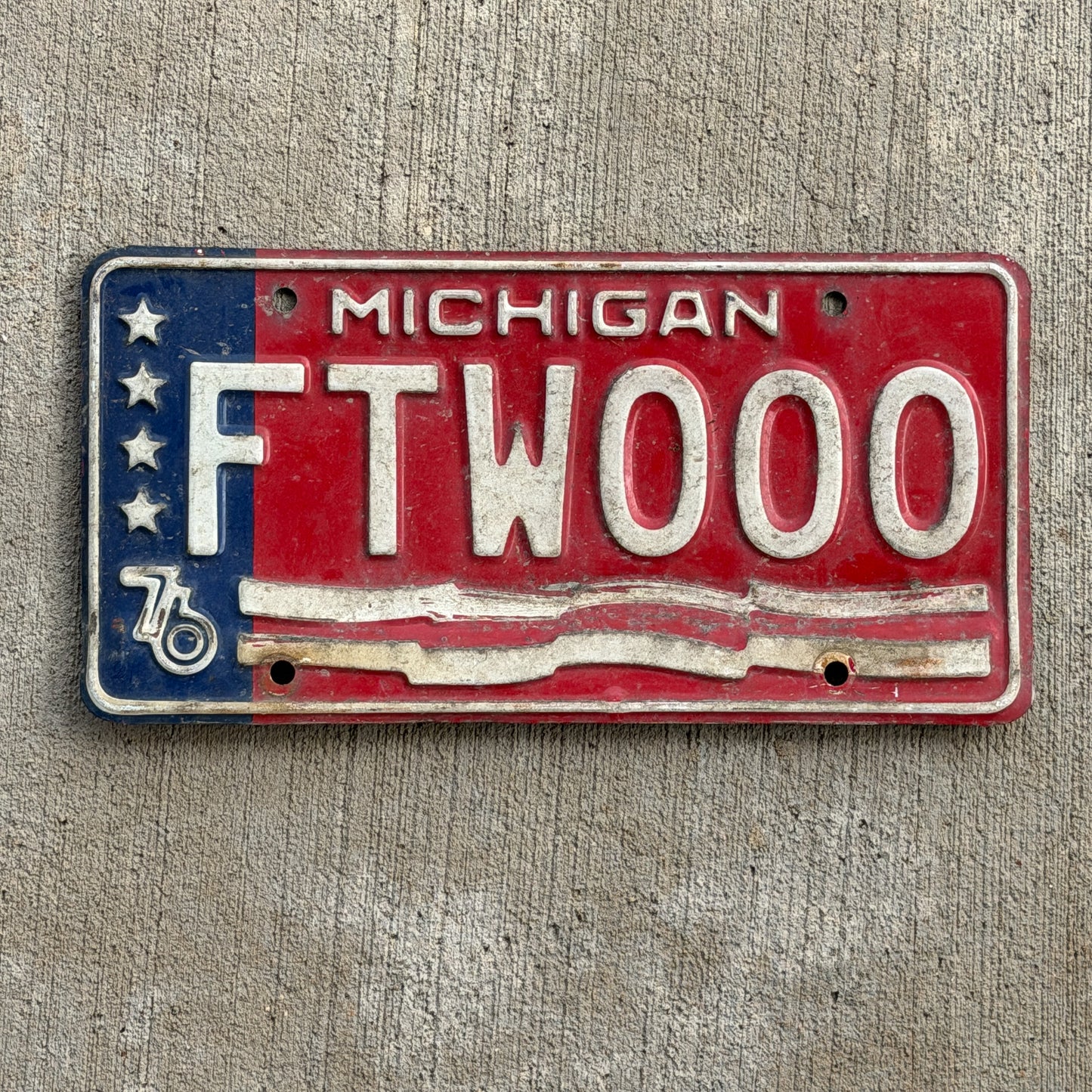 Photo of a 1976 Michigan License Plate Auto Tag Garage Decor Vintage Bicentennial Repeat Repeating FTW 000 with original patina