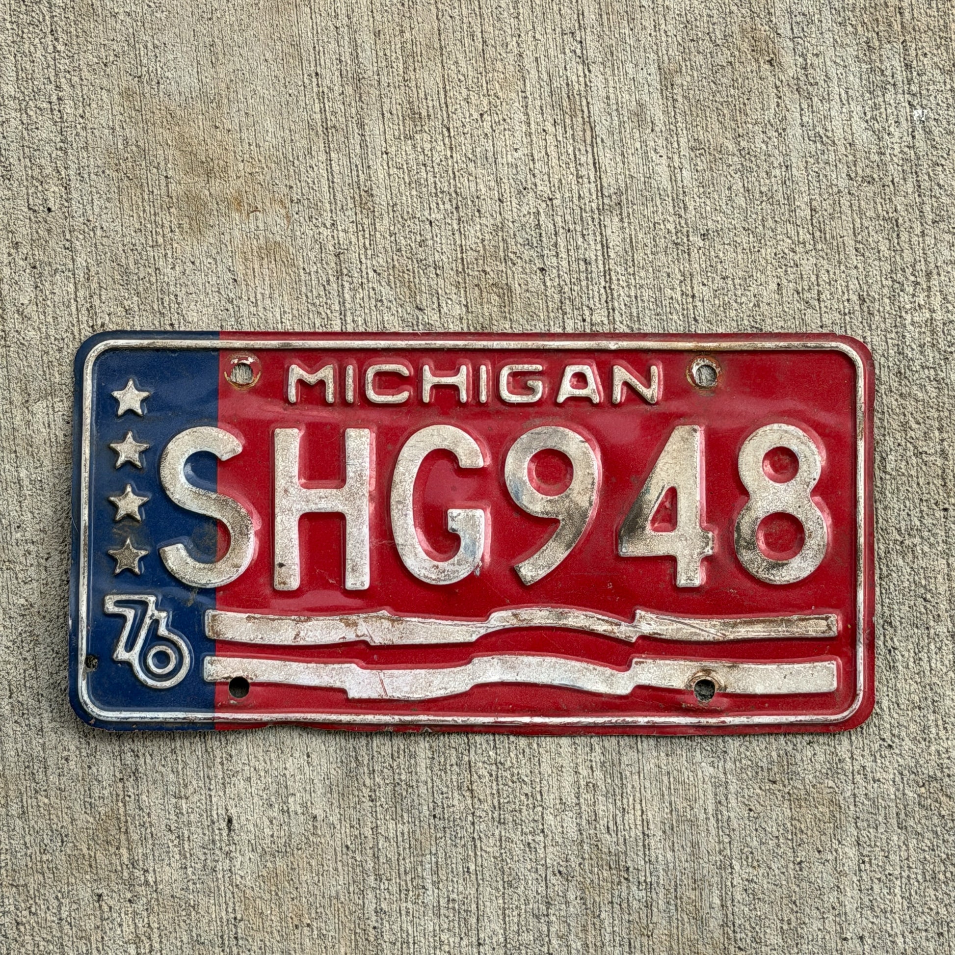 Photo of a 1976 Michigan License Plate Auto Tag Garage Decor Vintage Bicentennial SHG 948 with original patina