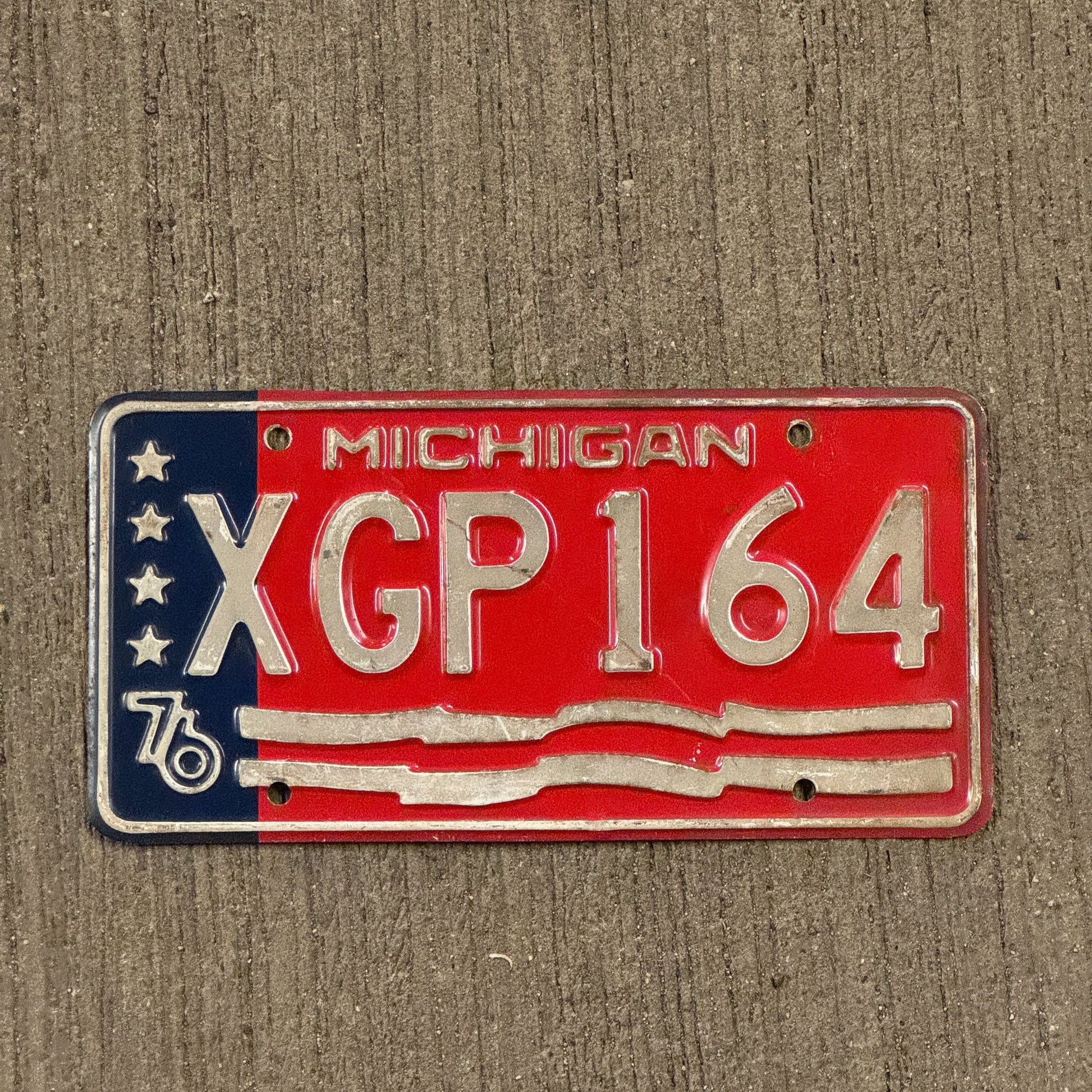 Photo of a 1976 Michigan License Plate Auto Tag Garage Decor Vintage Bicentennial XGP 164