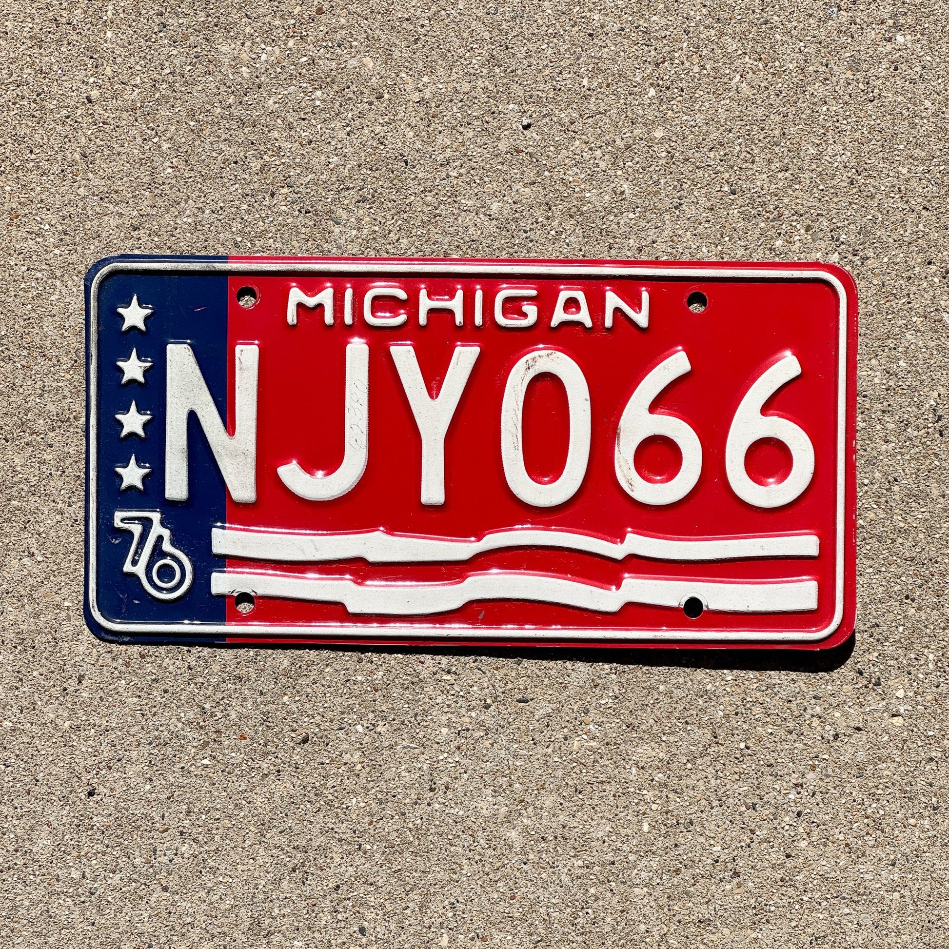 Photo of a 1976 Michigan License Plate Auto Tag Garage Decor Vintage NJY 066