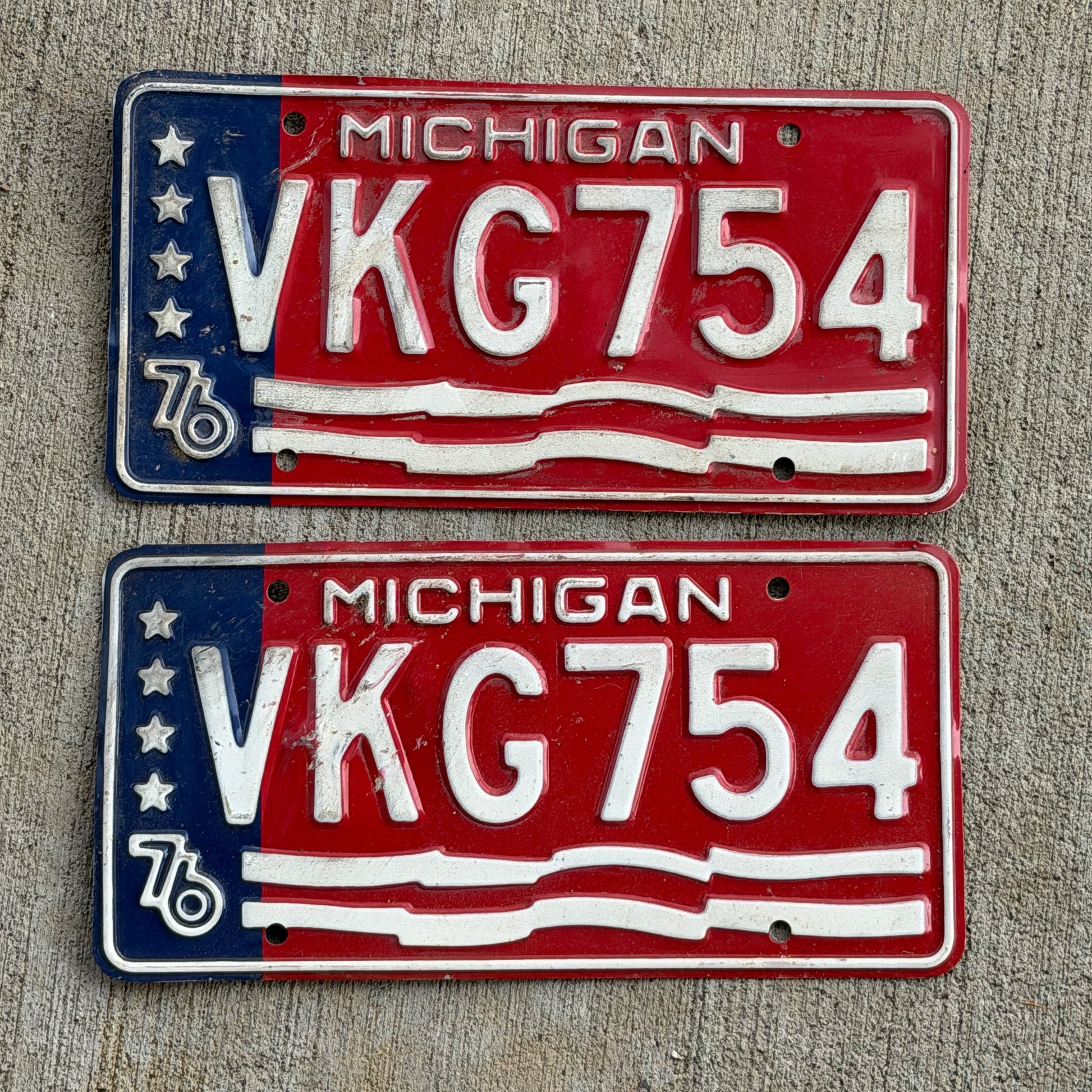 Photo of a 1976 Michigan License Plate Pair Auto Tag Garage Decor Vintage Bicentennial VKG 754 with original patina
