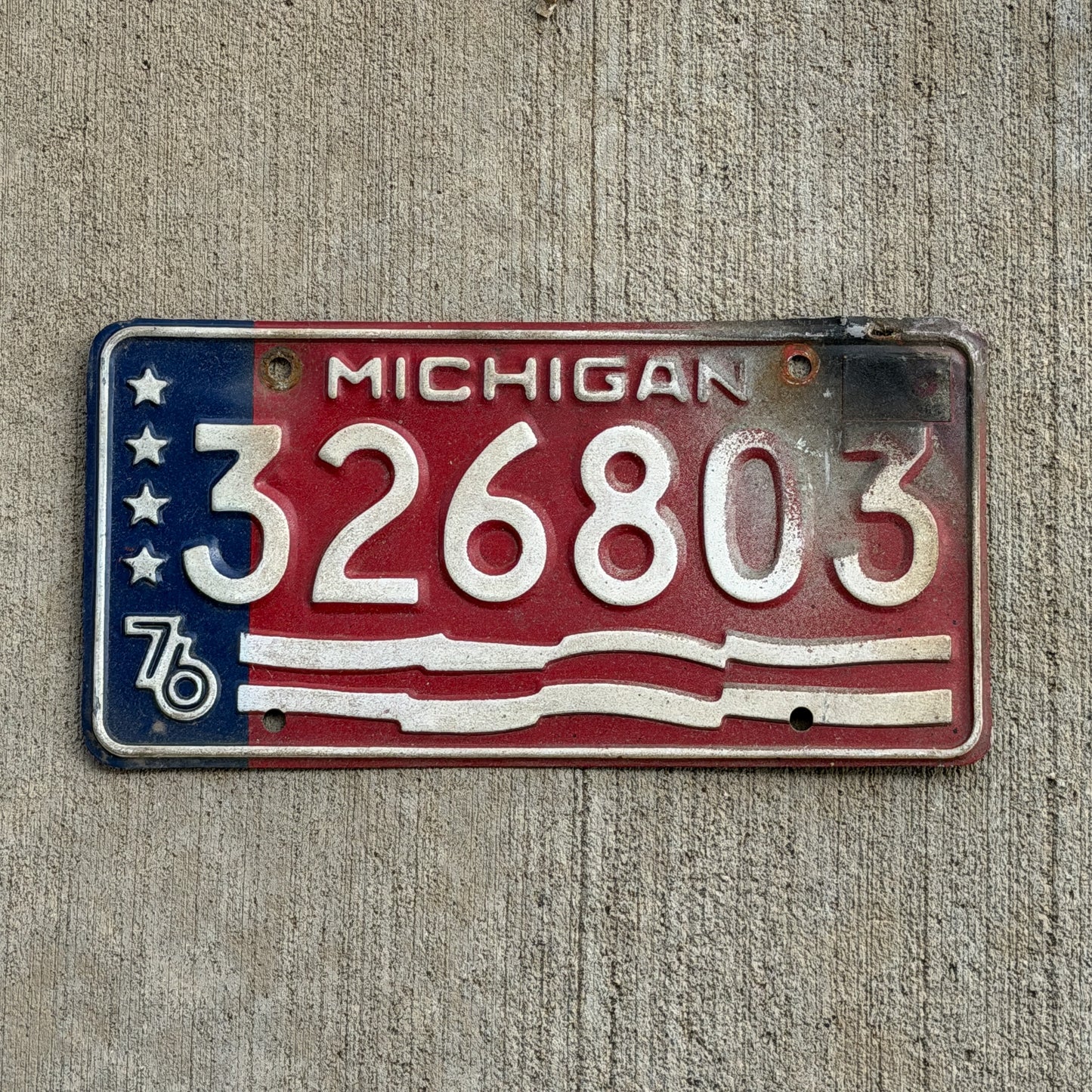 Photo of a 1976 Michigan Trailer License Plate Auto Tag Garage Decor Vintage Bicentennial 326 803 with original patina