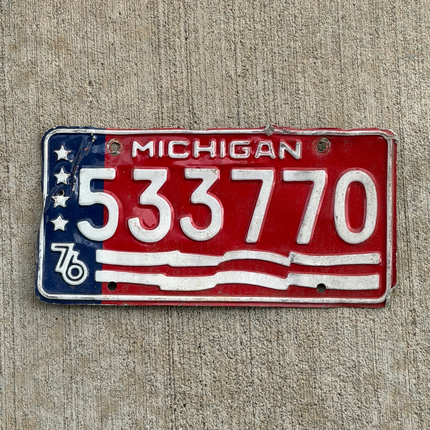 Photo of a 1976 Michigan Trailer License Plate Auto Tag Garage Decor Vintage Bicentennial 533 770 with original patina