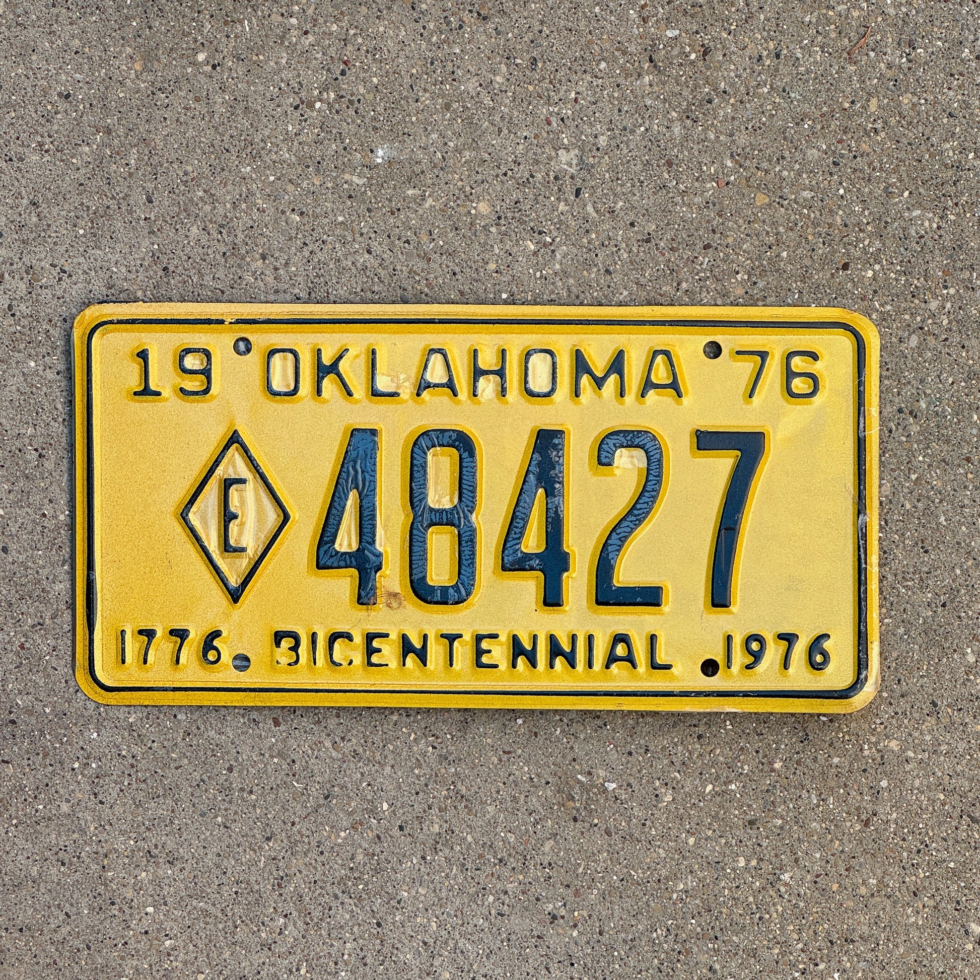 Photo of a 1976 Oklahoma Exempt License Plate Auto Tag Garage Decor Vintage Diamond E Fire State Police 48427 with original patina