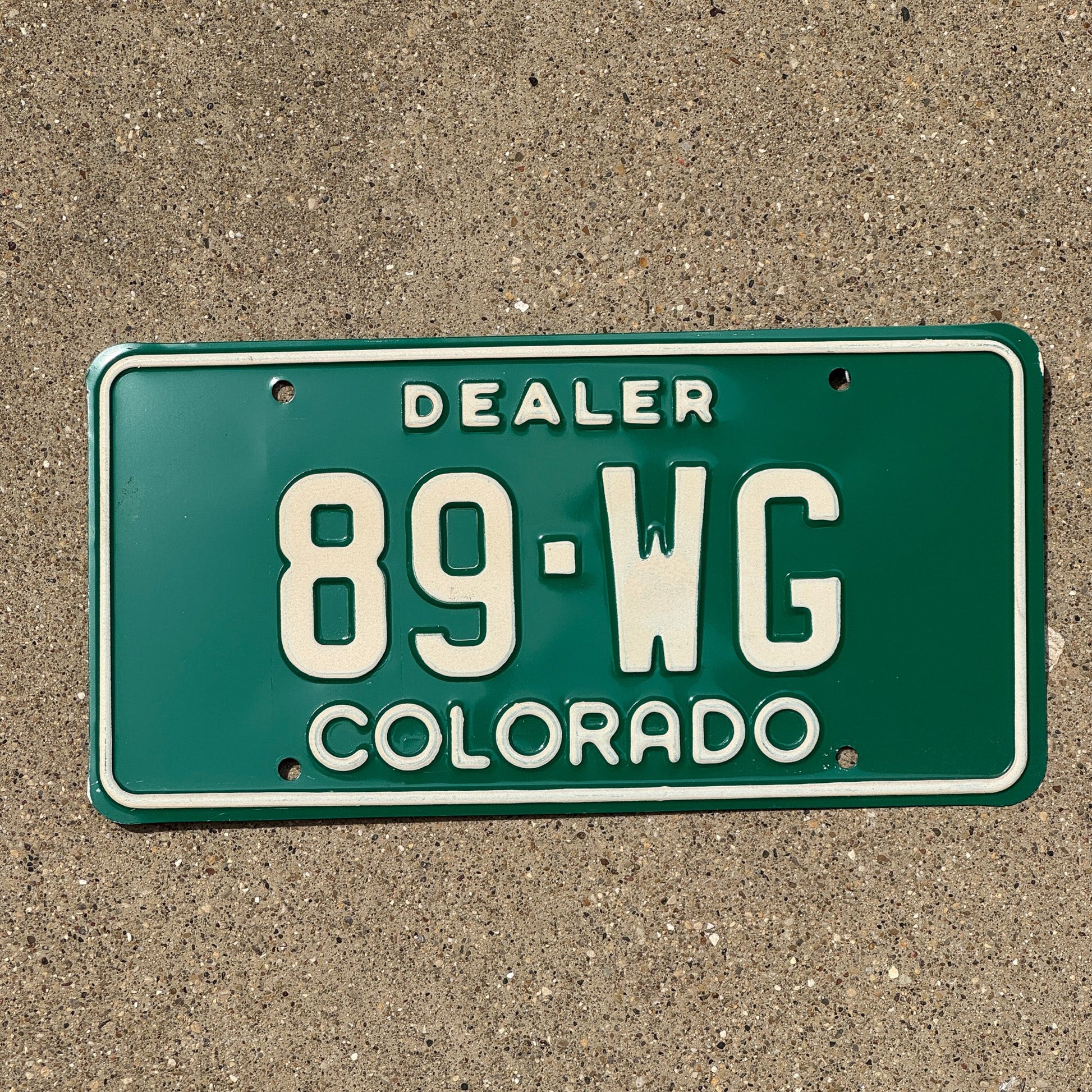 Photo of a 1977 Colorado Dealer License Plate Auto Tag 1 Garage Decor 89 WG