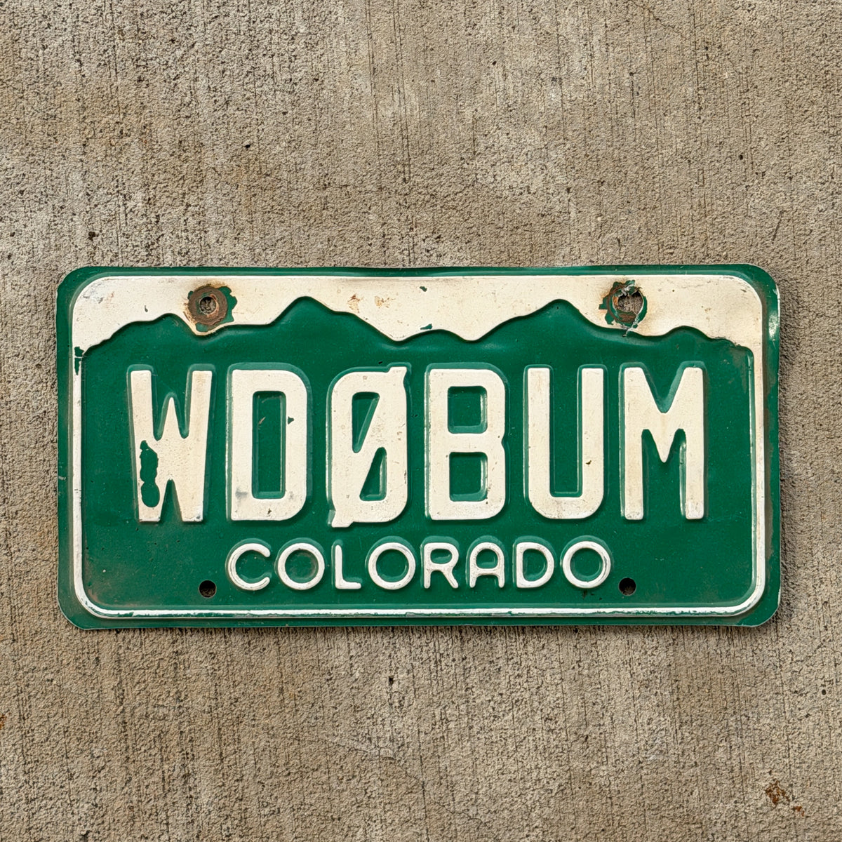 Photo of a 1977 Colorado Ham Radio License Plate Auto Tag Garage Decor Vintage WD 0 BUM with original patina