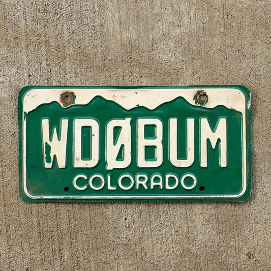 Photo of a 1977 Colorado Ham Radio License Plate Auto Tag Garage Decor Vintage WD 0 BUM with original patina