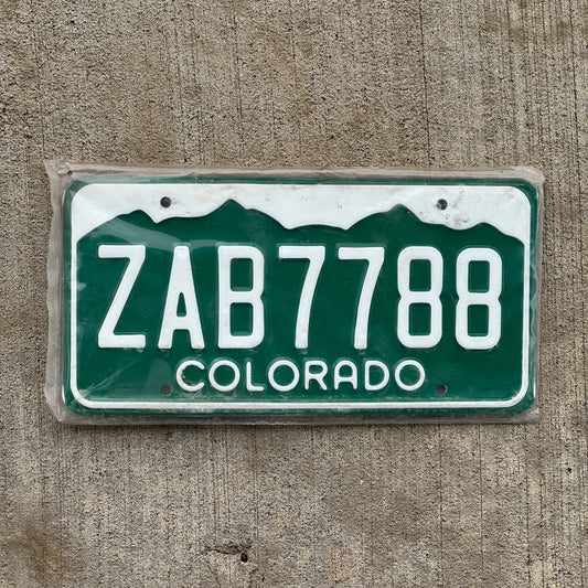 Photo of a 1977 Colorado License Plate Auto Tag Garage Decor Vintage New Old Stock NOS ZAB 7788 with original patina