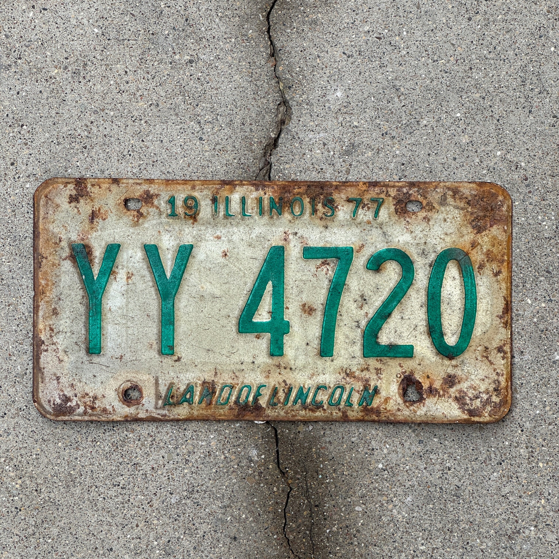 Photo of a 1977 Illinois License Plate Auto Tag Garage Decor Vintage YY 4720 with original patina