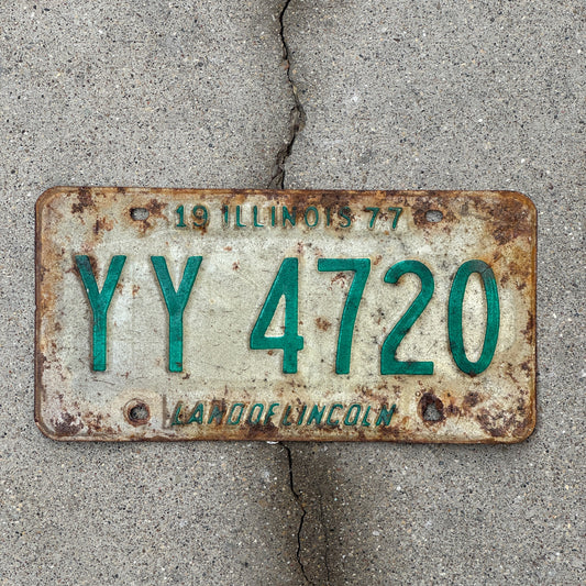 Photo of a 1977 Illinois License Plate Auto Tag Garage Decor Vintage YY 4720 with original patina