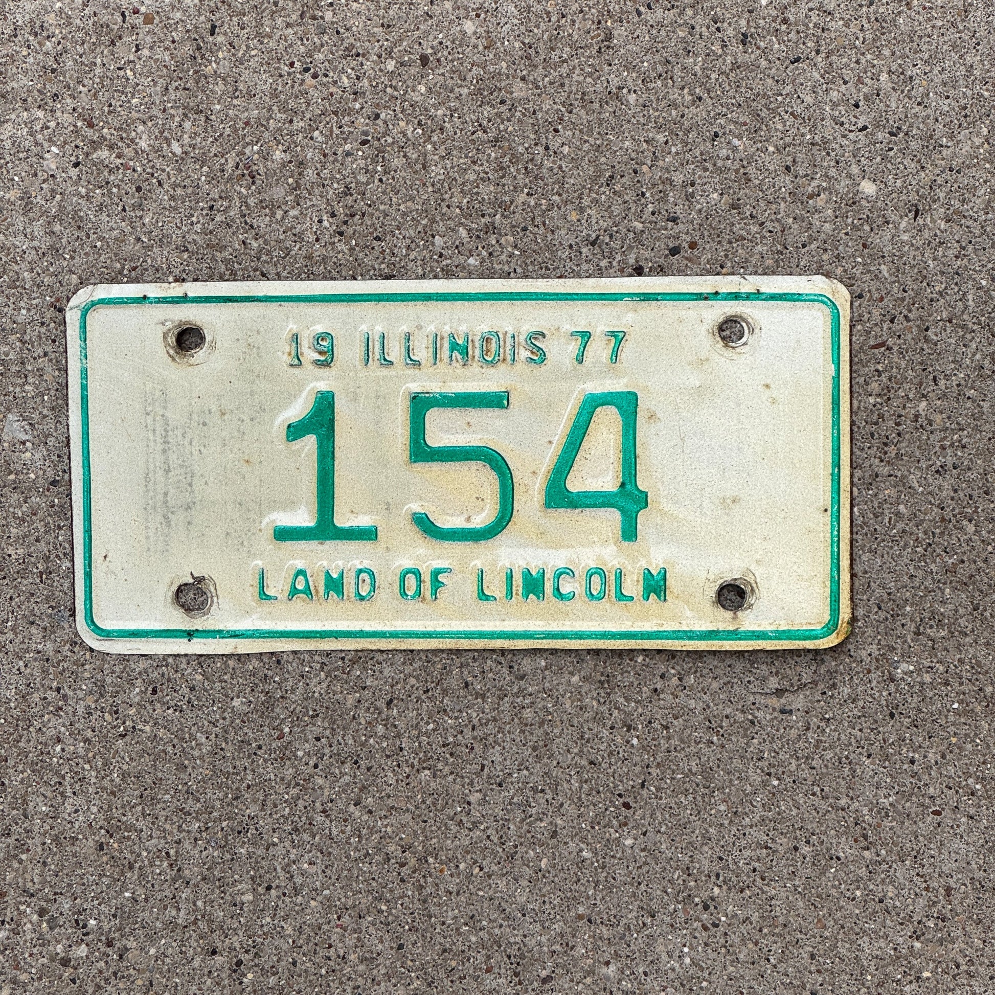 Photo of a 1977 Illinois Motorcycle License Plate Auto Tag Garage Decor Vintage Low Number Three Digit 154 with original patina