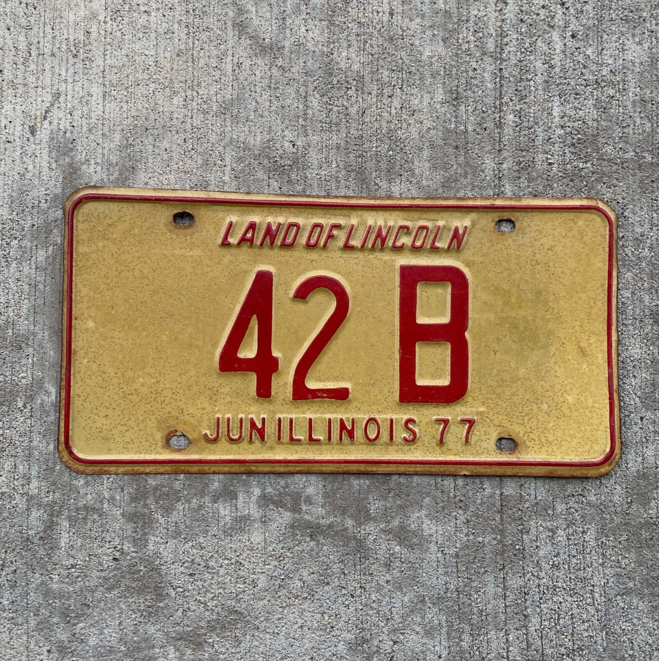 Photo of a 1977 Illinois Truck License Plate Auto Tag Garage Decor Vintage Low Number Two Digit 42 B with original patina