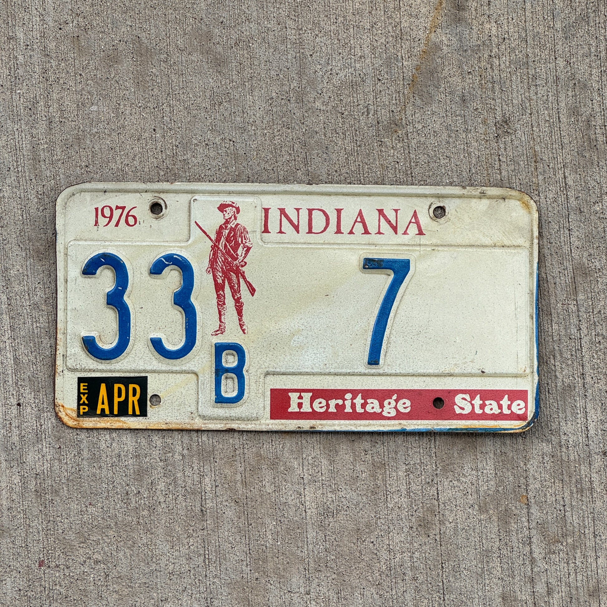 Photo of a 1977 Indiana License Plate Auto Tag Garage Decor Vintage Henry County Low Number 33 B 7 with original patina