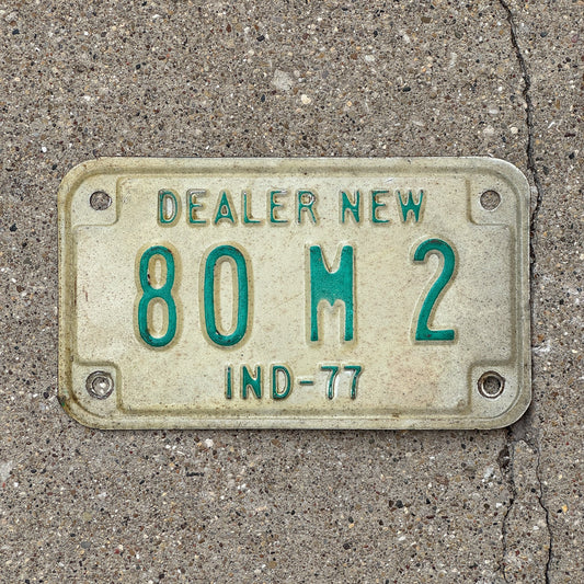 Photo of a 1977 Indiana Motorcycle Dealer License Plate Auto Tag Garage Decor Vintage 80 M 2 with original patina