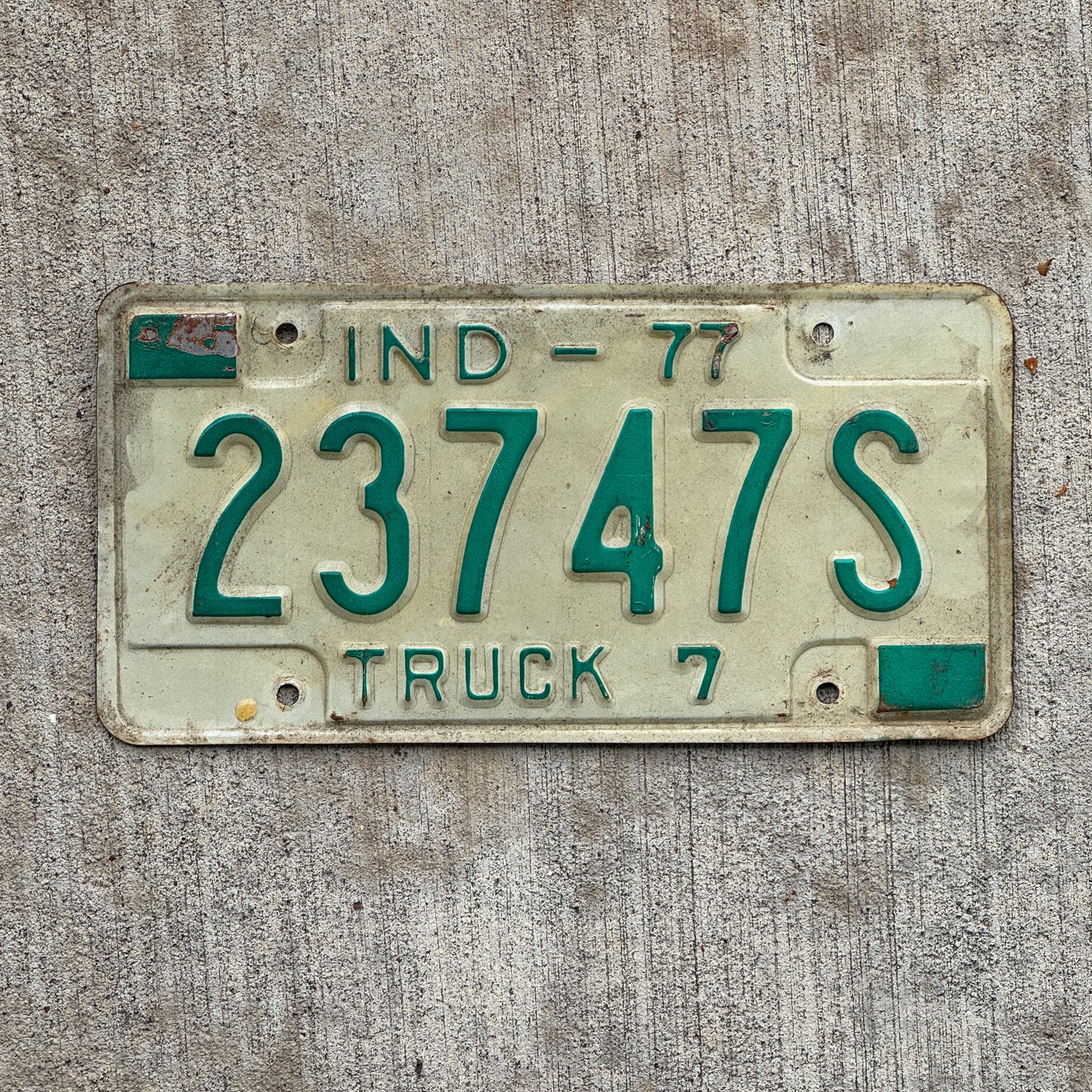 Photo of a 1977 Indiana Truck License Plate Auto Tag Garage Decor Vintage 23747 S with original patina