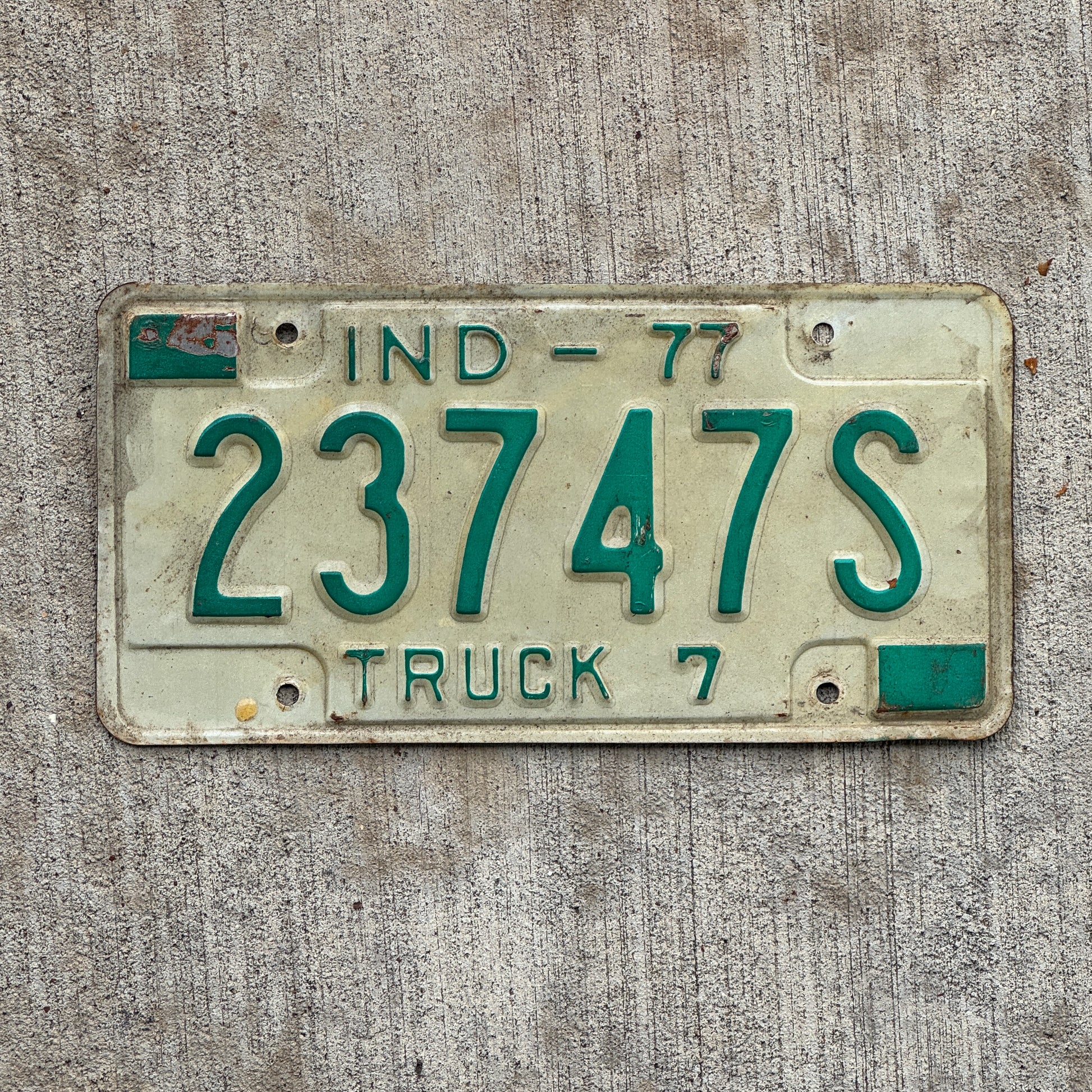 Photo of a 1977 Indiana Truck License Plate Auto Tag Garage Decor Vintage 23747 S with original patina