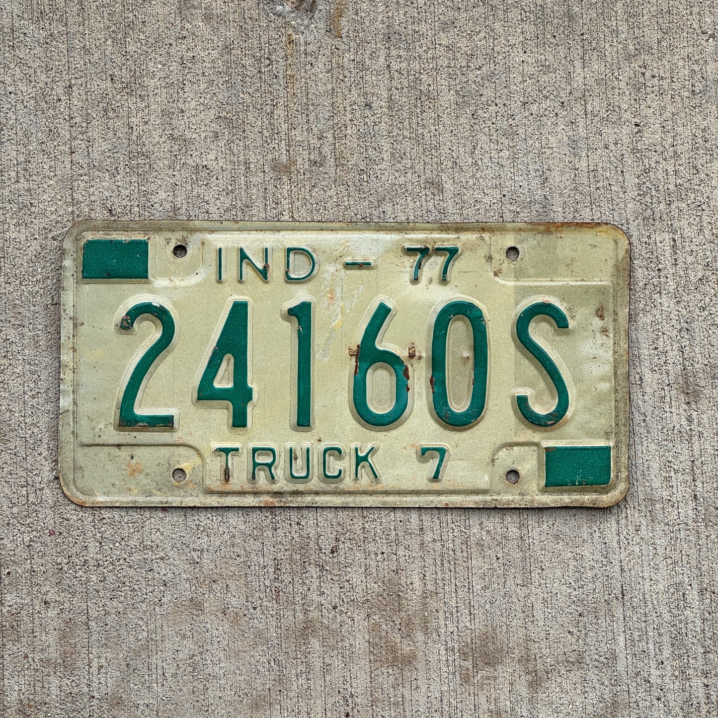 Photo of a 1977 Indiana Truck License Plate Auto Tag Garage Decor Vintage 24160 S with original patina