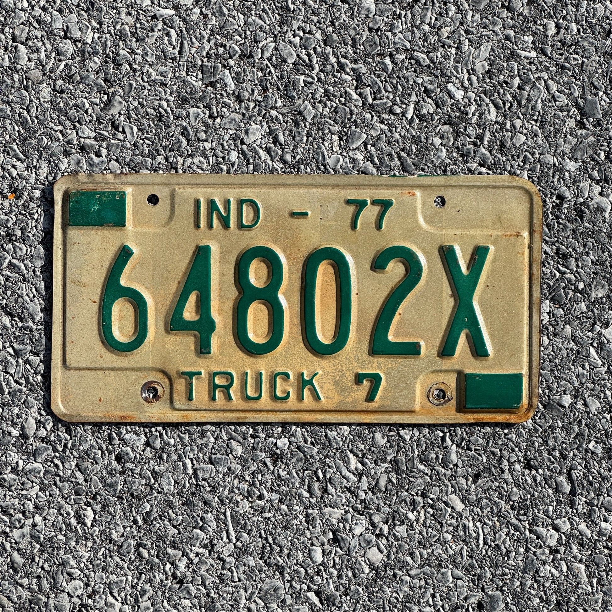 Photo of a 1977 Indiana Truck License Plate Auto Tag Garage Decor Vintage 64802X