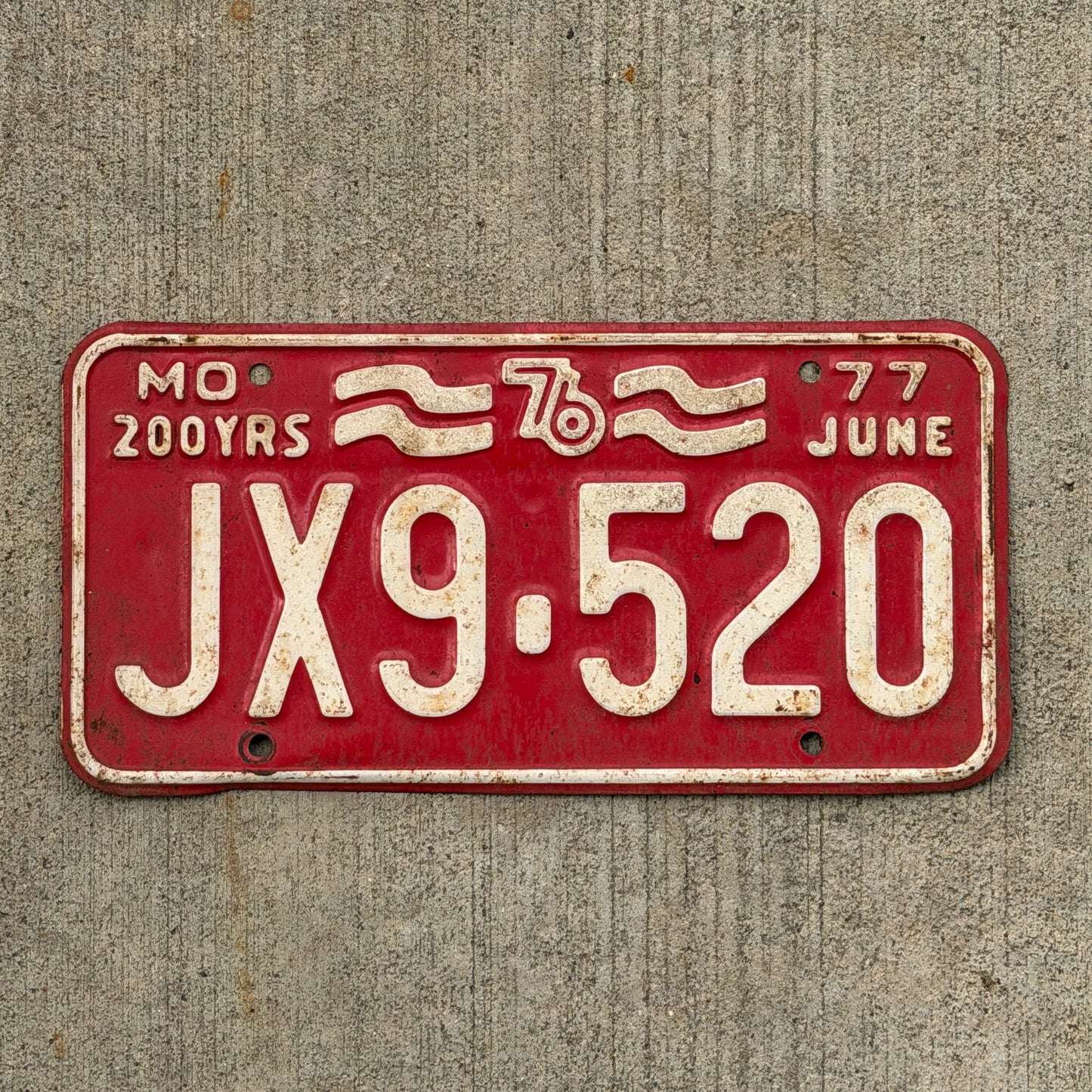 Photo of a 1977 Missouri License Plate Auto Tag Garage Decor Vintage Bicentennial JX 9 520 with original patina