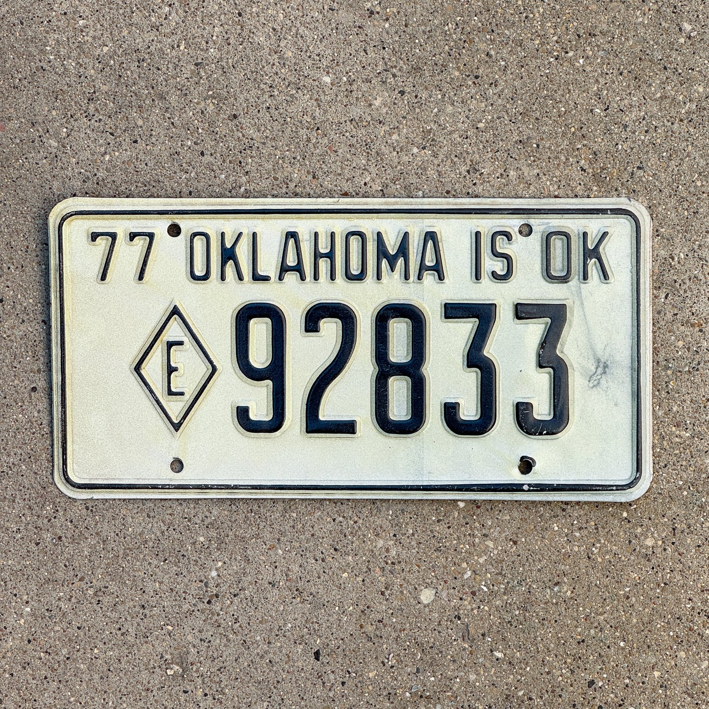Photo of a 1977 Oklahoma Exempt License Plate Auto Tag Garage Decor Vintage Diamond E Fire State Police 92833 with original patina
