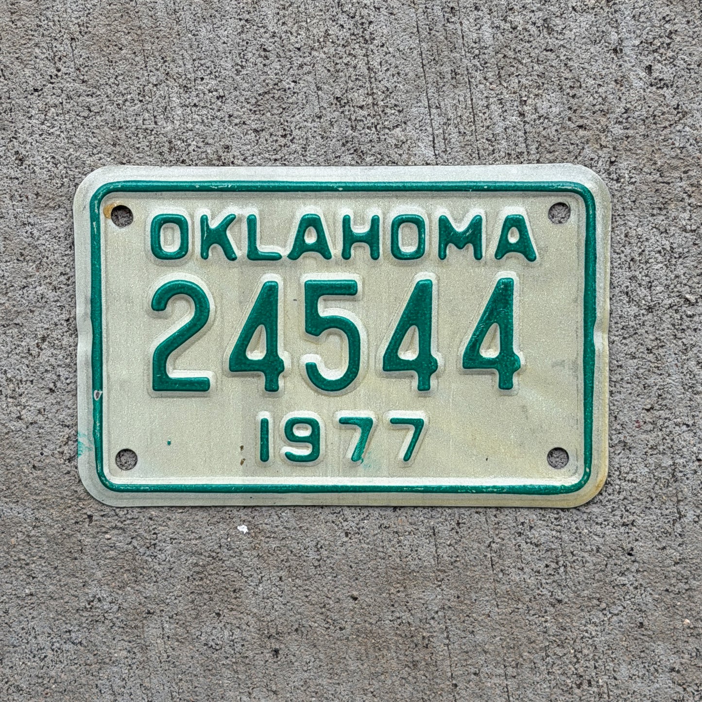 Photo of a 1977 Oklahoma Motorcycle License Plate Auto Tag Garage Decor Vintage 24544 with original patina