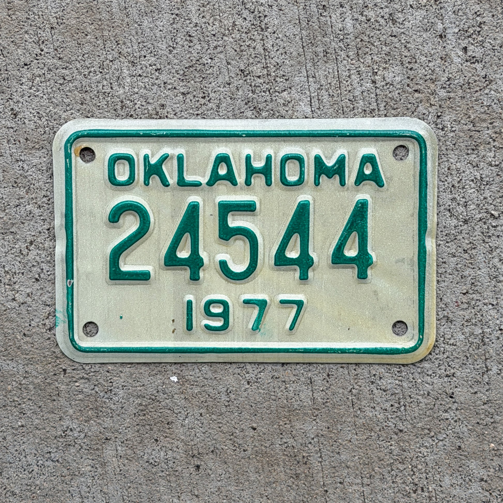 Photo of a 1977 Oklahoma Motorcycle License Plate Auto Tag Garage Decor Vintage 24544 with original patina