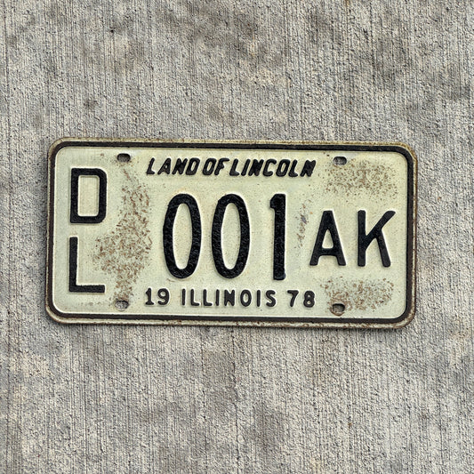 Photo of a 1978 Illinois Dealer License Plate Auto Tag Garage Decor Vintage Great Number 001 AK with original patina