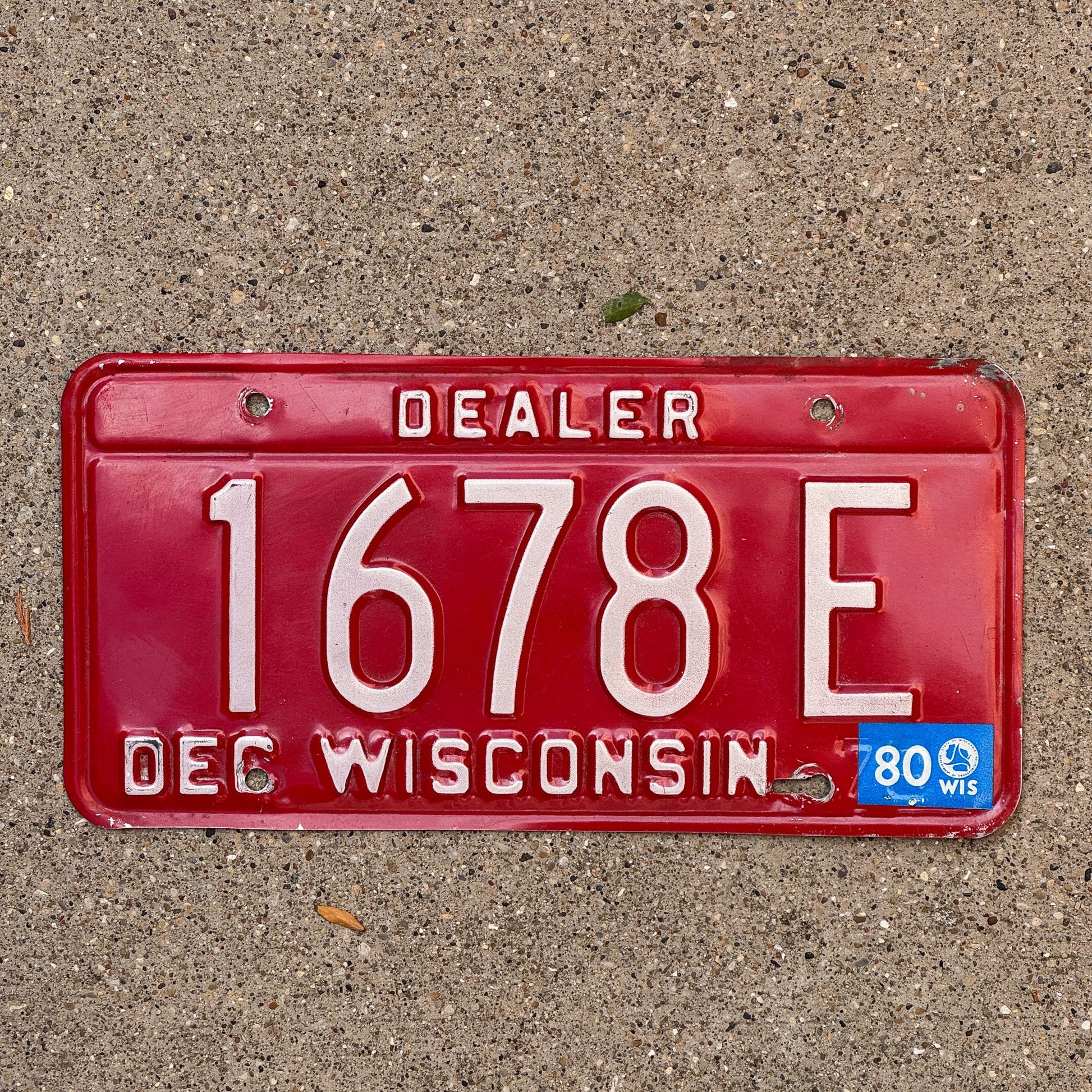 Photo of a 1979 1980 Wisconsin Dealer License Plate Auto Tag Garage Decor Vintage 1678 E with original patina