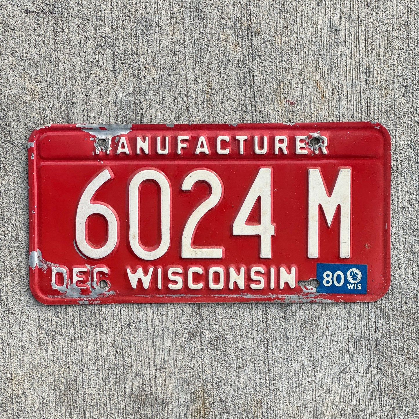 Photo of a 1979 1980 Wisconsin Manufacturer License Plate Auto Tag Garage Decor Vintage 6024 M with original patina