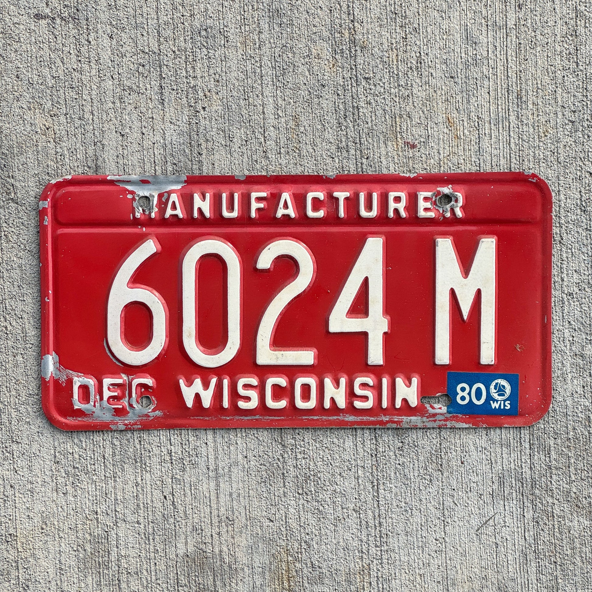 Photo of a 1979 1980 Wisconsin Manufacturer License Plate Auto Tag Garage Decor Vintage 6024 M with original patina