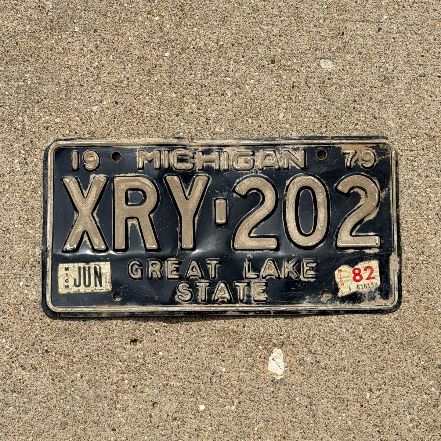 Photo of a 1979 1982 Michigan License Plate Auto Tag Garage Decor Vintage XRY 202 with original patina