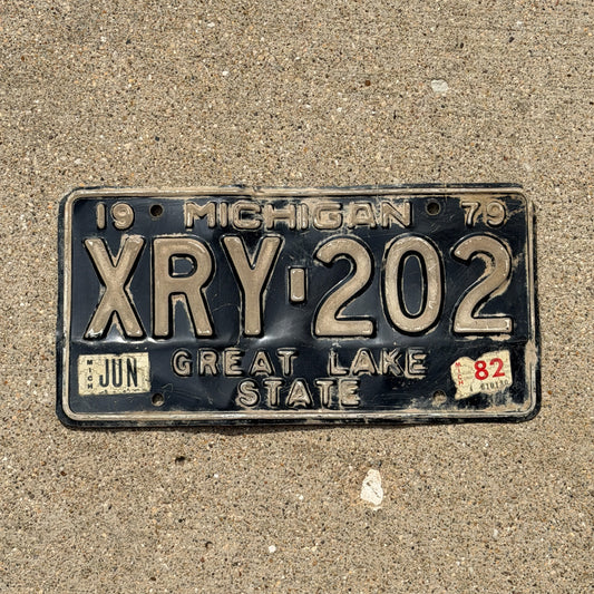 Photo of a 1979 1982 Michigan License Plate Auto Tag Garage Decor Vintage XRY 202 with original patina