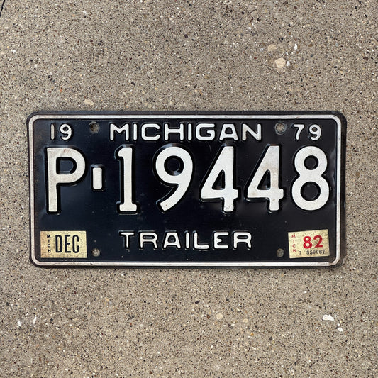 Photo of a 1979 1982 Michigan Trailer License Plate Auto Tag Garage Decor Vintage P 19448