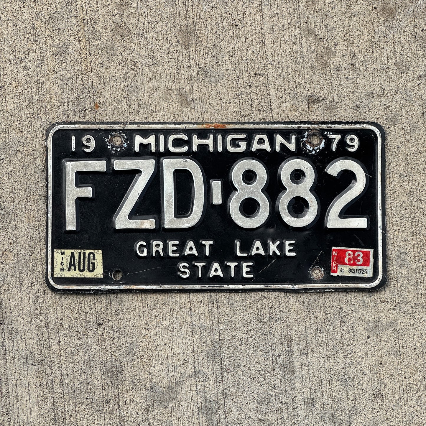 Photo of a 1979 1983 Michigan License Plate Auto Tag Garage Decor Vintage FZD 882 with original patina