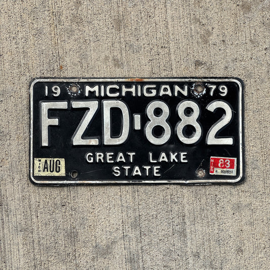 Photo of a 1979 1983 Michigan License Plate Auto Tag Garage Decor Vintage FZD 882 with original patina