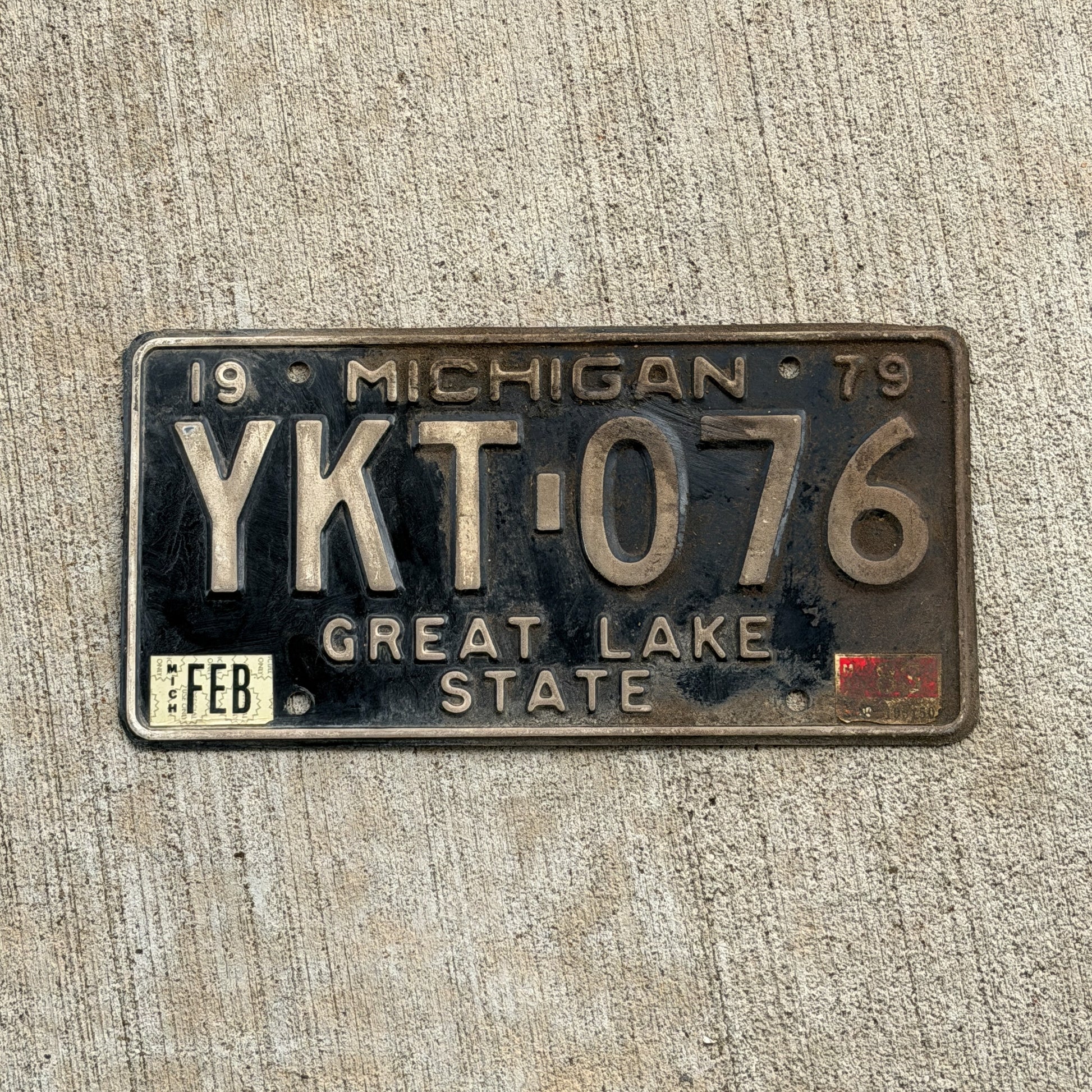 Photo of a 1979 1983 Michigan License Plate Auto Tag Garage Decor Vintage YKT 076 with original patina