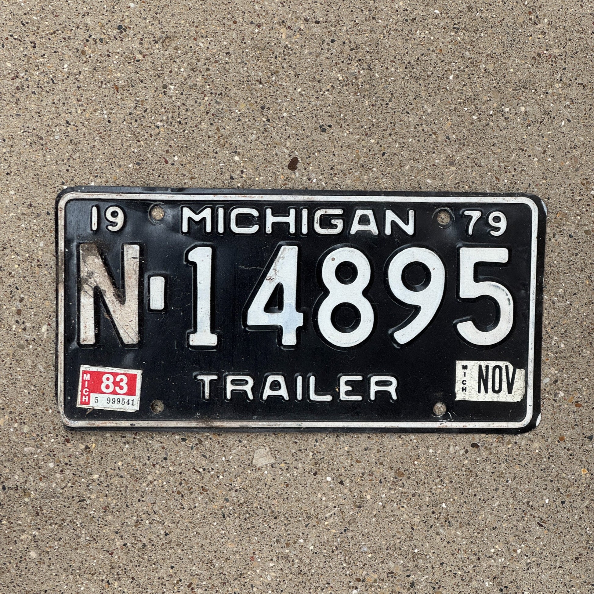 Photo of a 1979 1983 Michigan Trailer License Plate Auto Tag Garage Decor Vintage N 14895