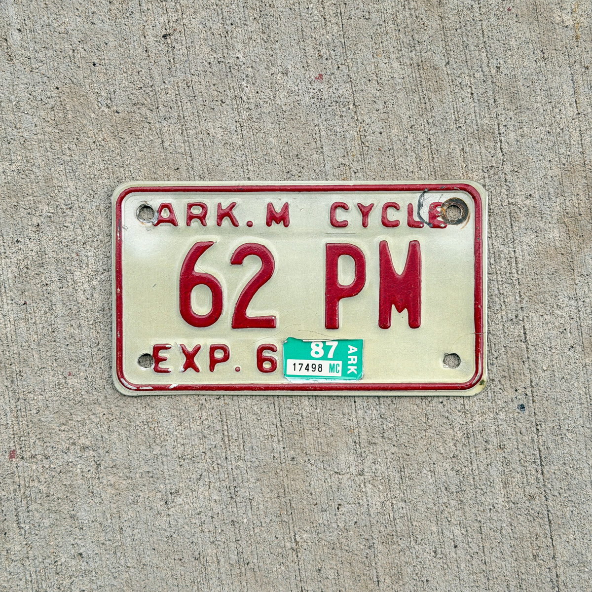 Photo of a 1979 1987 Arkansas Motorcycle License Plate Auto Tag Garage Decor Vintage 62 PM with original patina