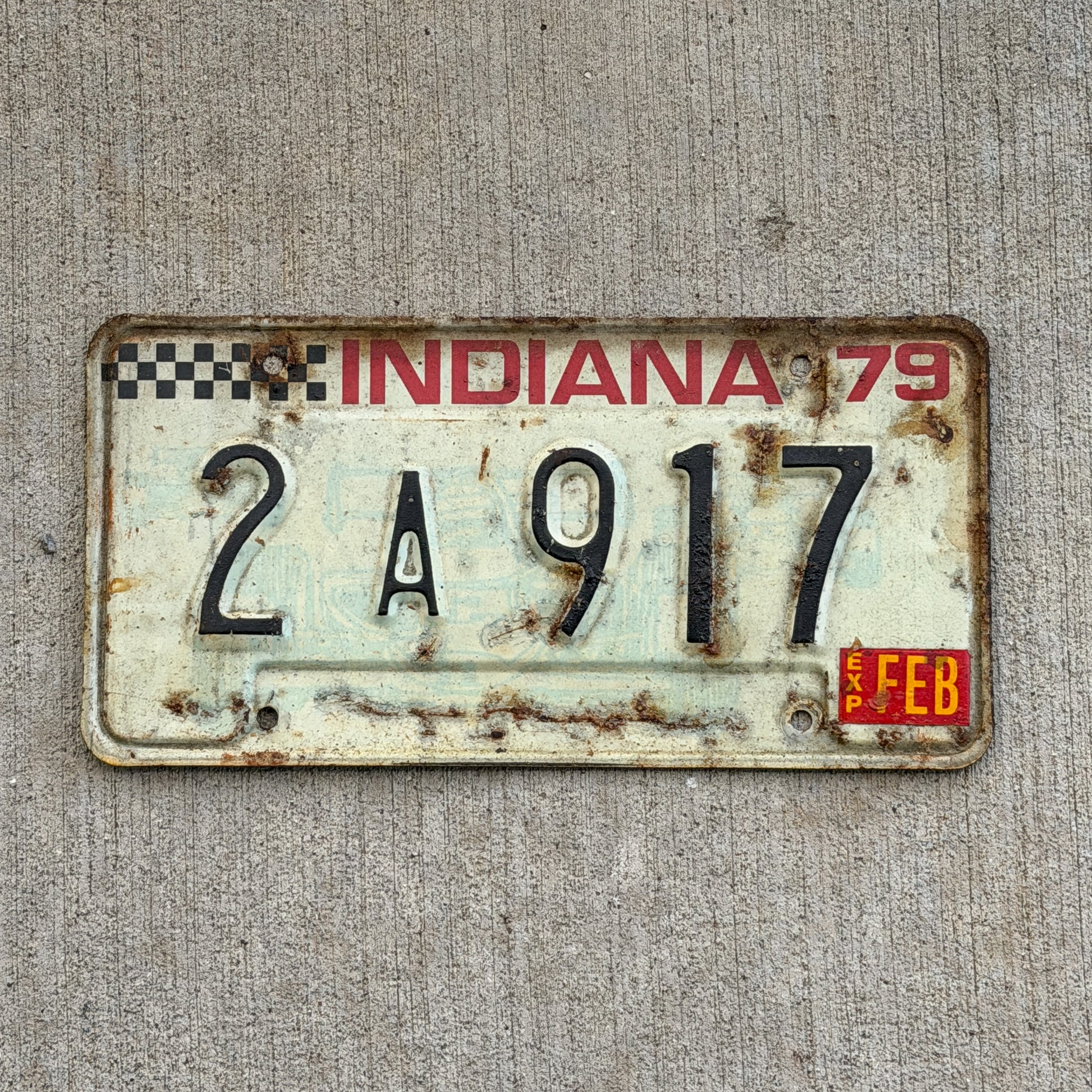 Photo of a 1979 Indiana License Plate Auto Tag Garage Decor Vintage Checkered Race Car 2 A 917 with original patina