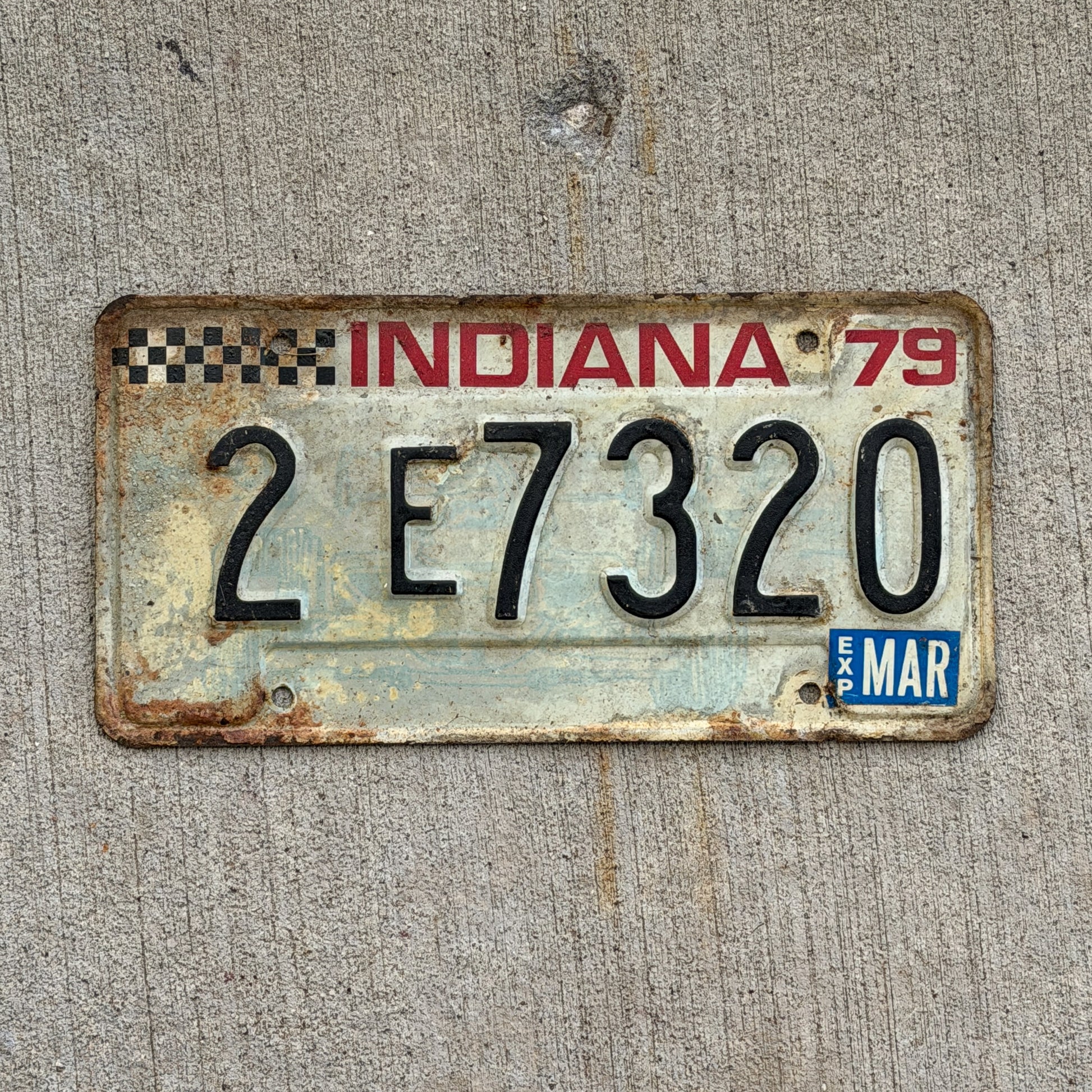 Photo of a 1979 Indiana License Plate Auto Tag Garage Decor Vintage Checkered Race Car 2 E 7320 with original patina