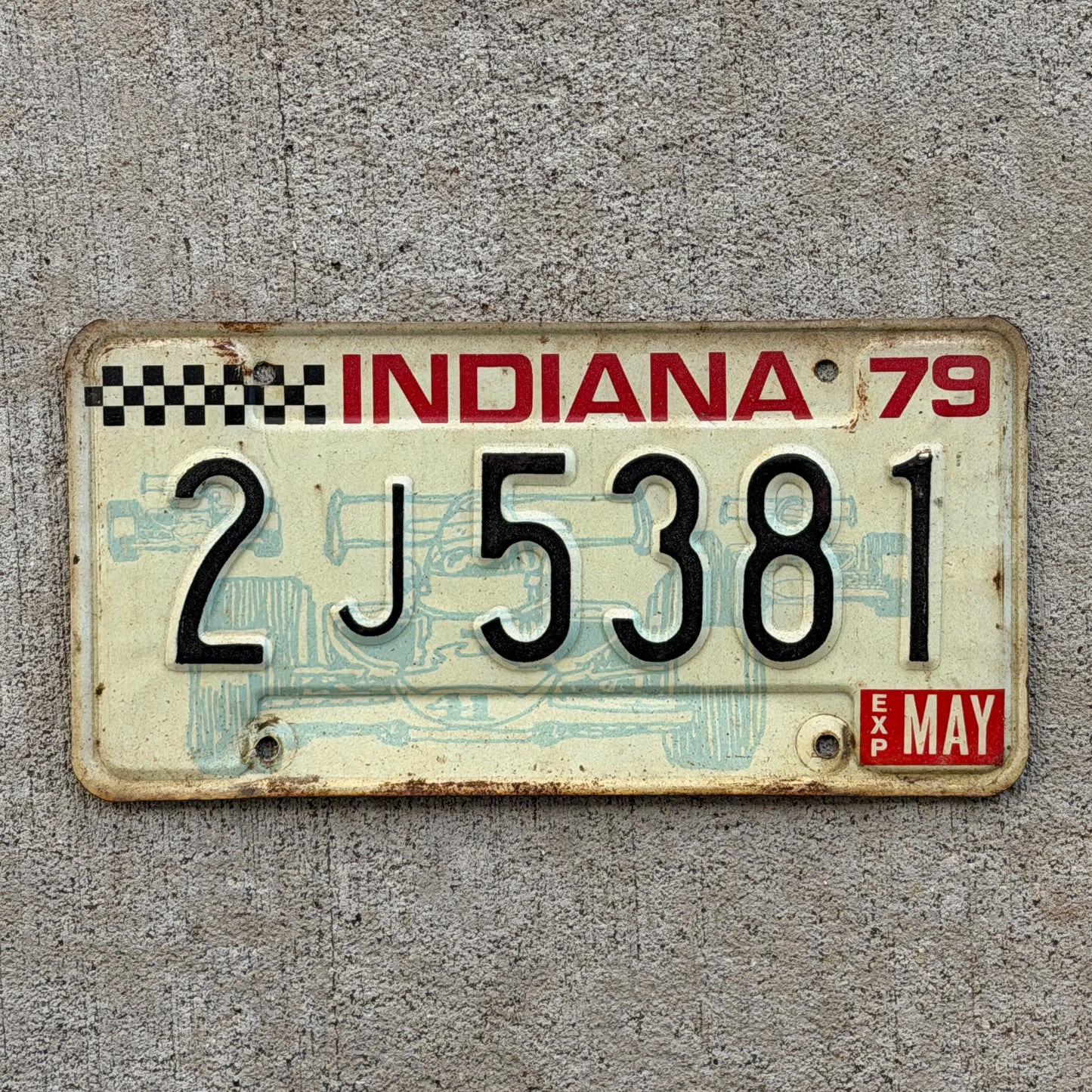 Photo of a 1979 Indiana License Plate Auto Tag Garage Decor Vintage Checkered Race Car 2 J 5381 with original patina