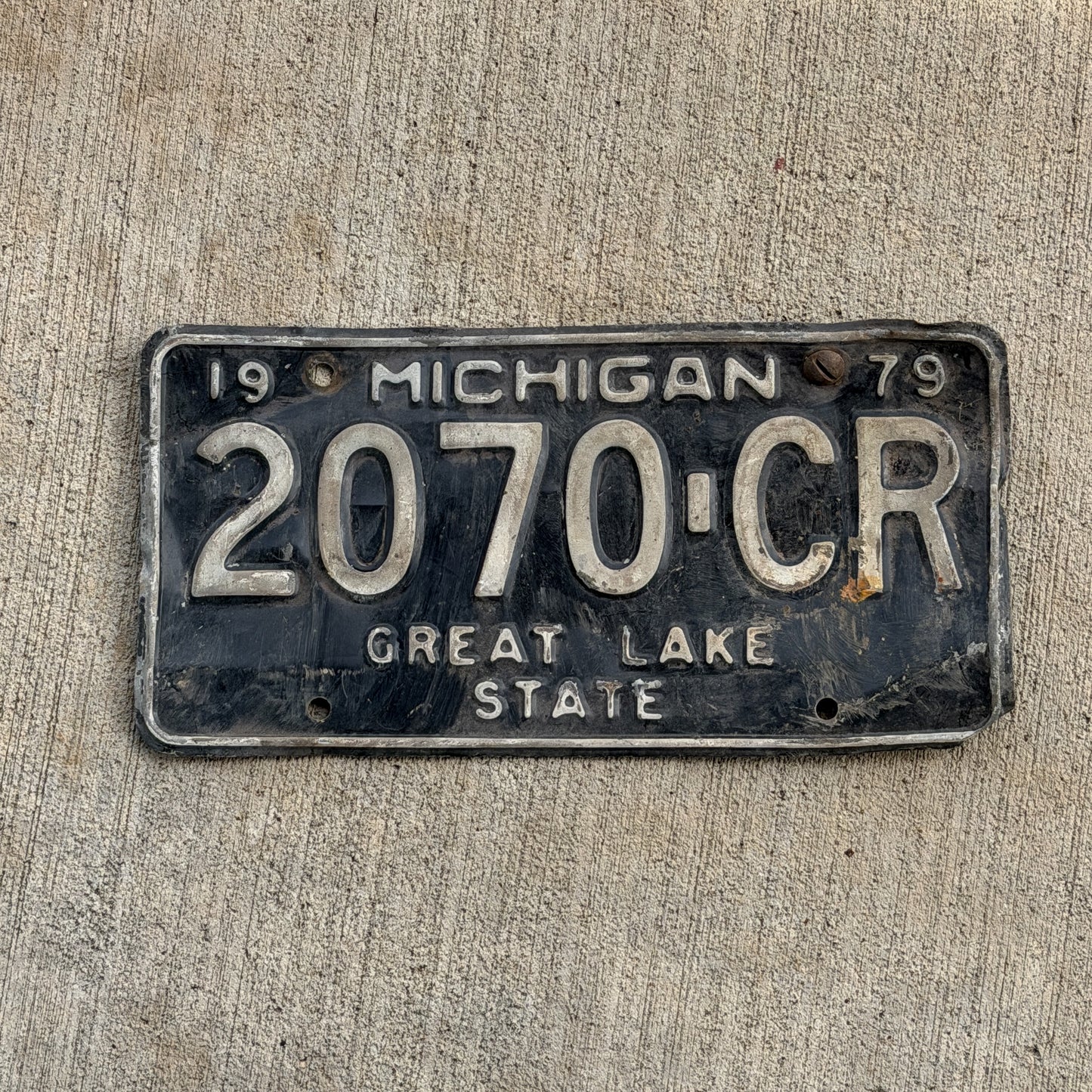 Photo of a 1979 Michigan Commercial License Plate Auto Tag Garage Decor Vintage 2070 CR with original patina