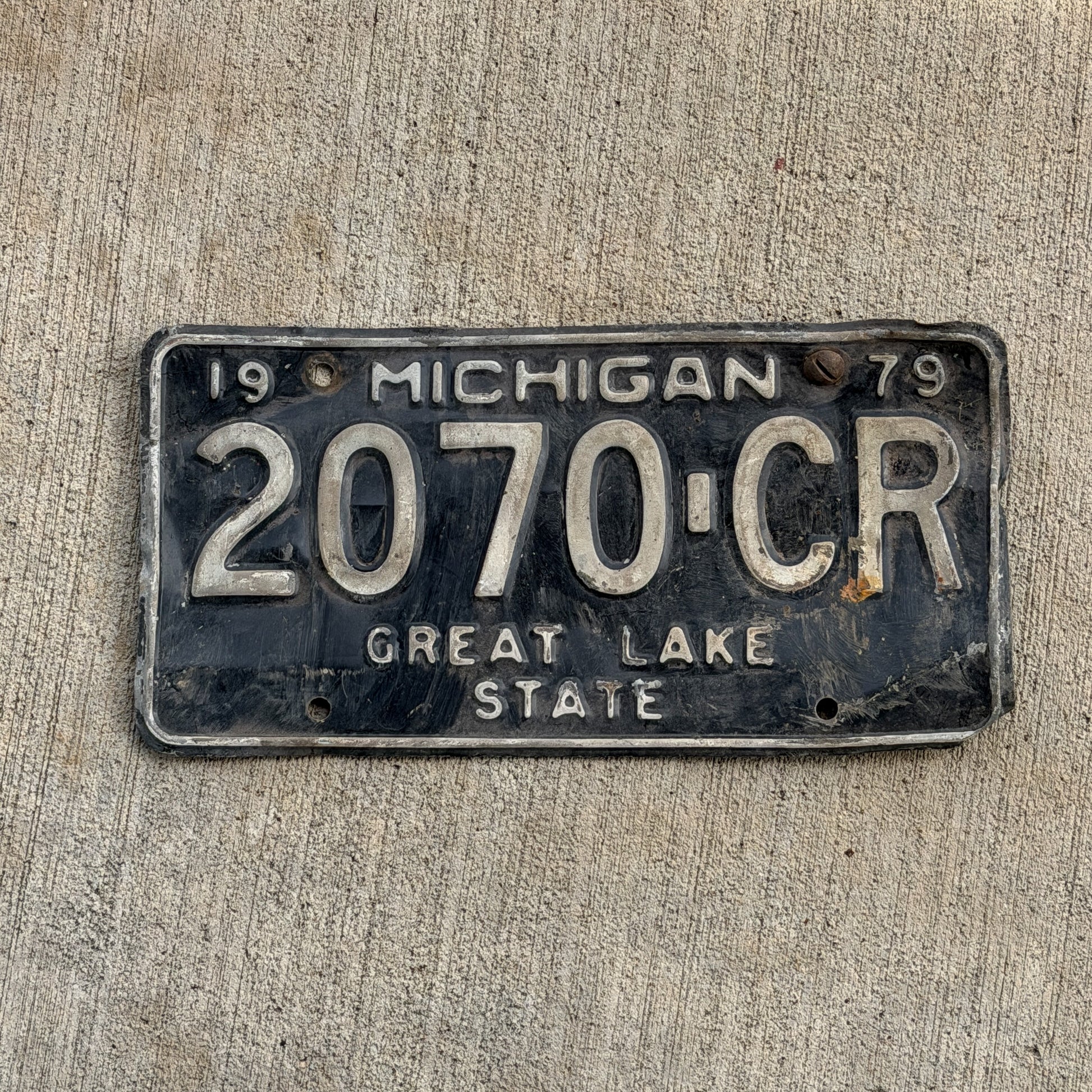 Photo of a 1979 Michigan Commercial License Plate Auto Tag Garage Decor Vintage 2070 CR with original patina