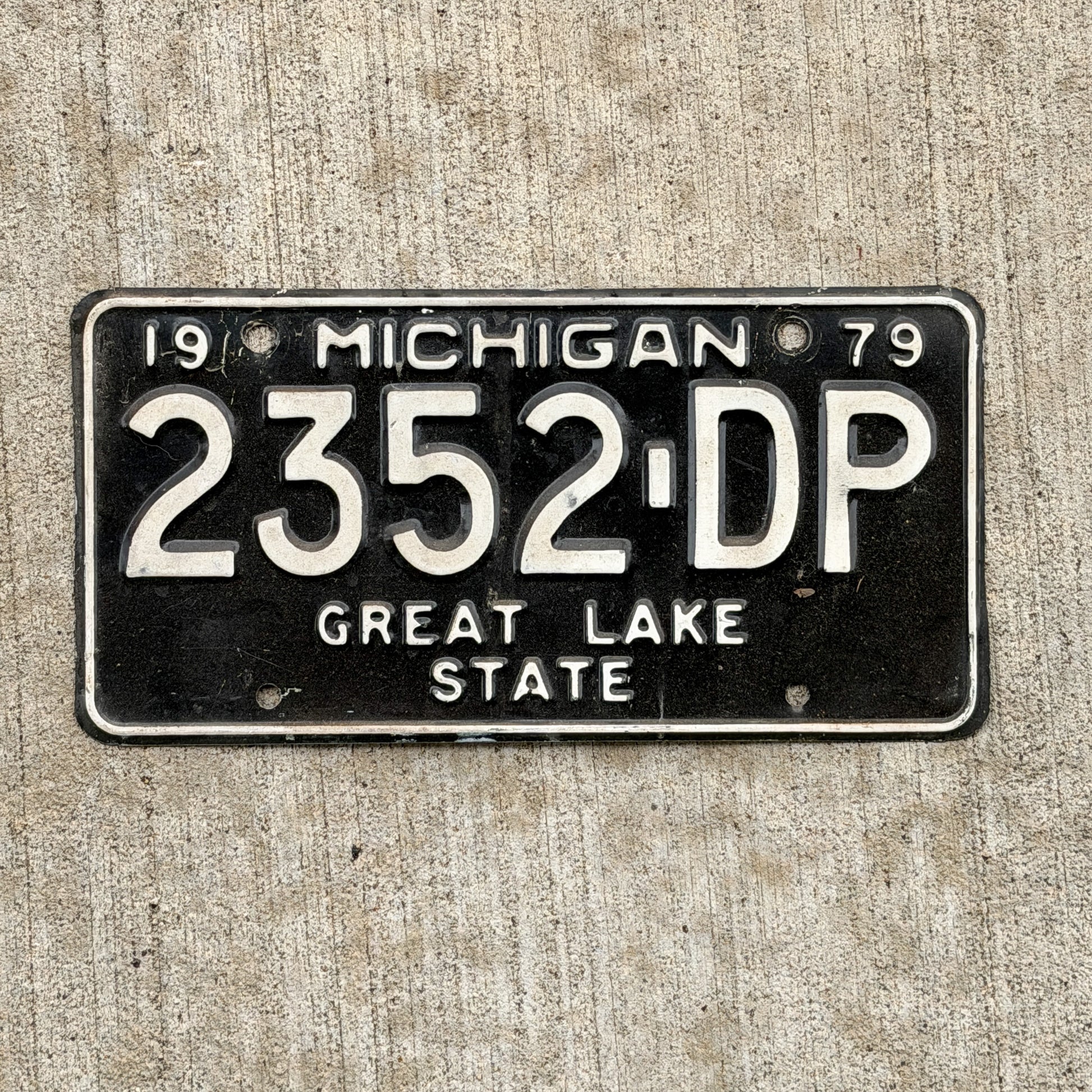 Photo of a 1979 Michigan Commercial License Plate Auto Tag Garage Decor Vintage 2352 DP with original patina