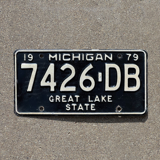 Photo of a 1979 Michigan Commercial License Plate Auto Tag Garage Decor Vintage 7426 DB with original patina