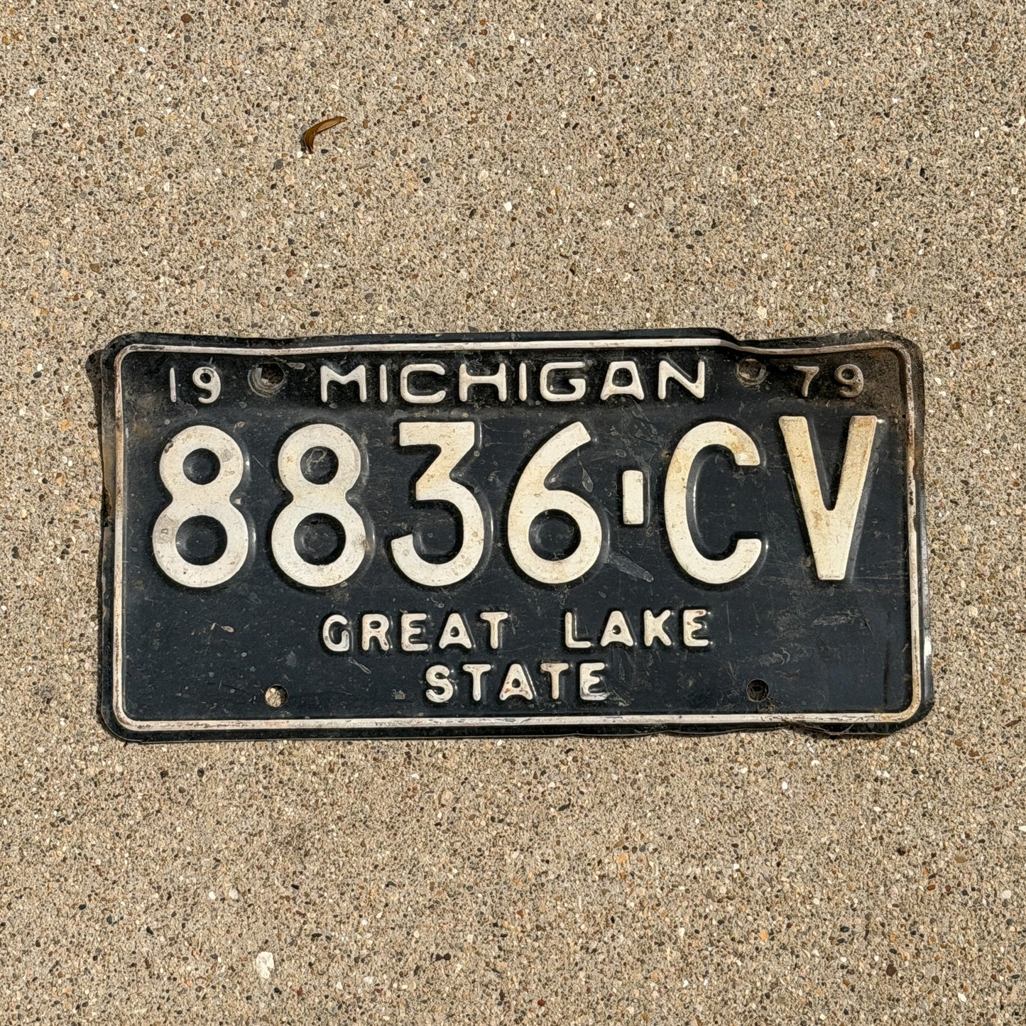 Photo of a 1979 Michigan Commercial License Plate Auto Tag Garage Decor Vintage 8836 CV with original patina
