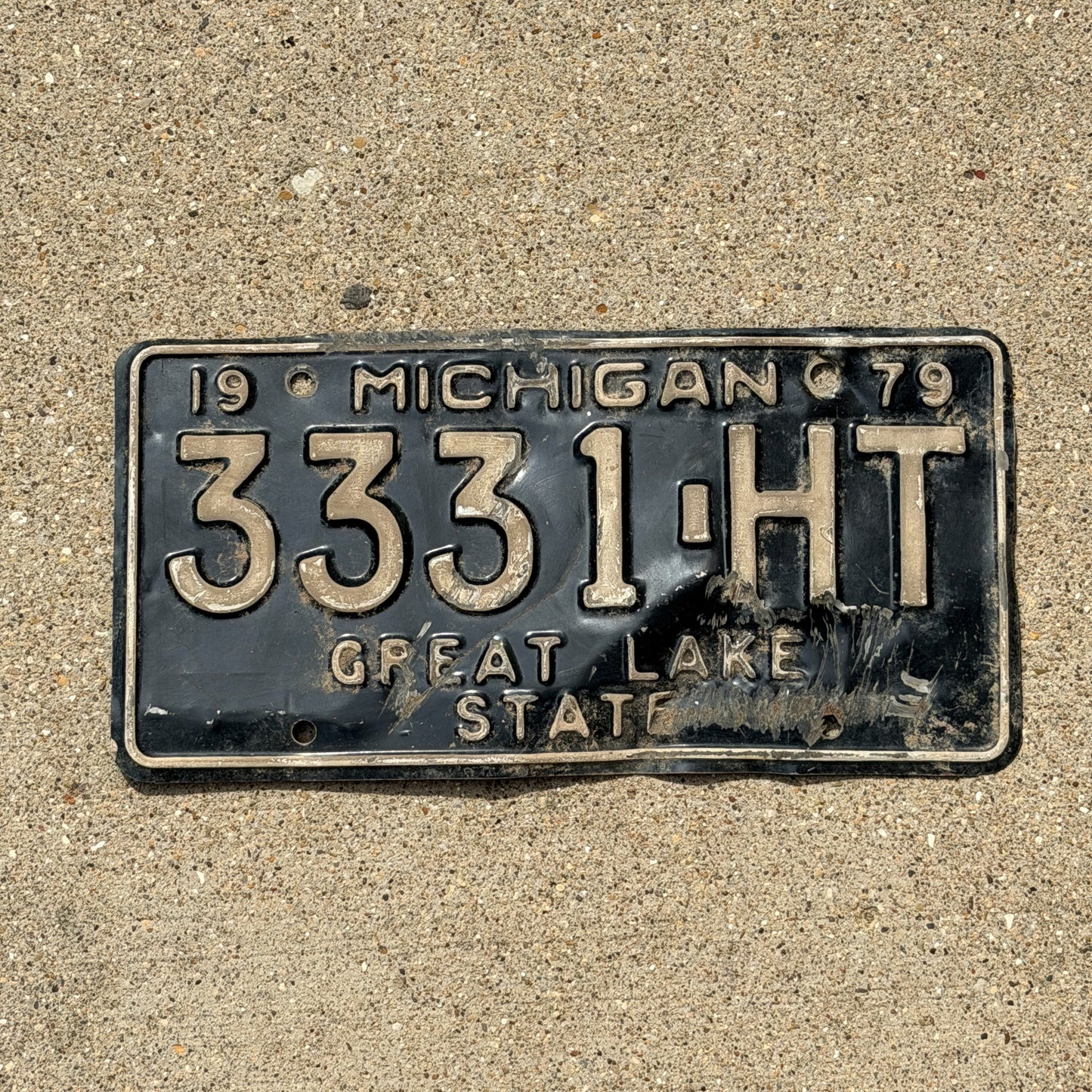 Photo of a 1979 Michigan Commercial License Plate Auto Tag Garage Decor Vintage Repeat Repeating 3331 HT with original patina