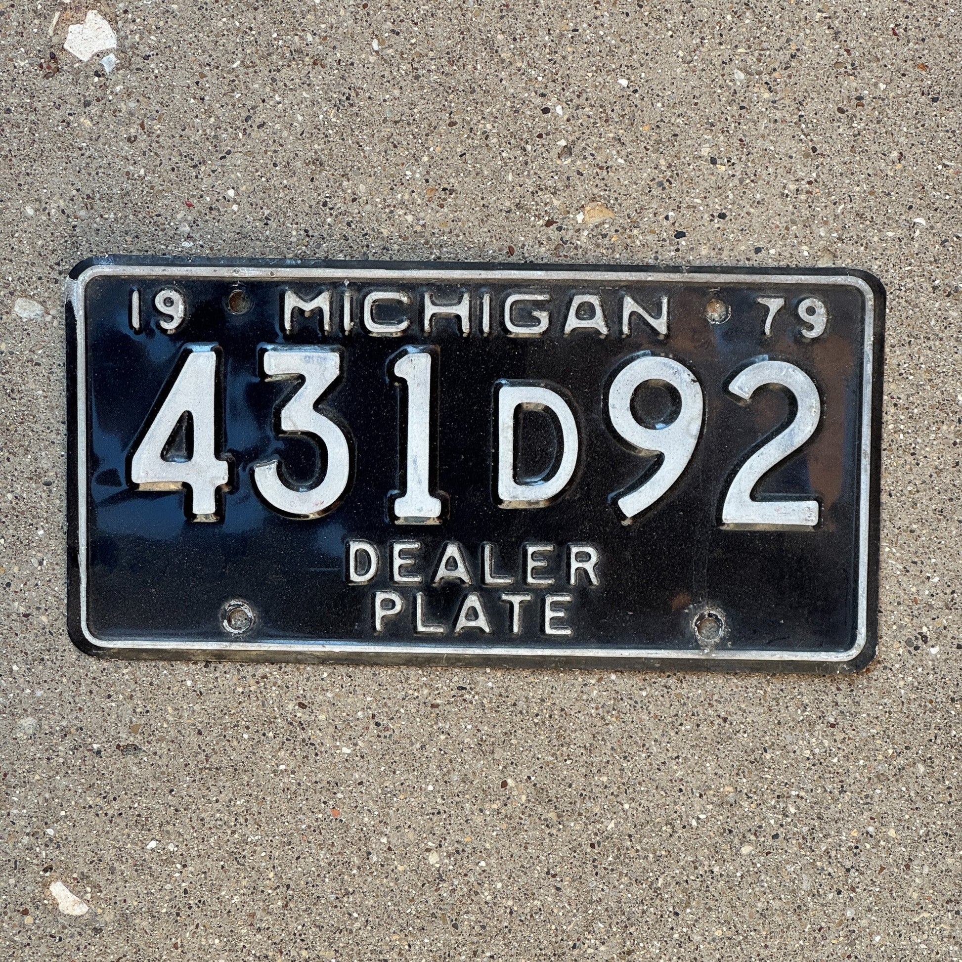 Photo of a 1979 Michigan Dealer License Plate Auto Tag Garage Decor Vintage 431 D 92