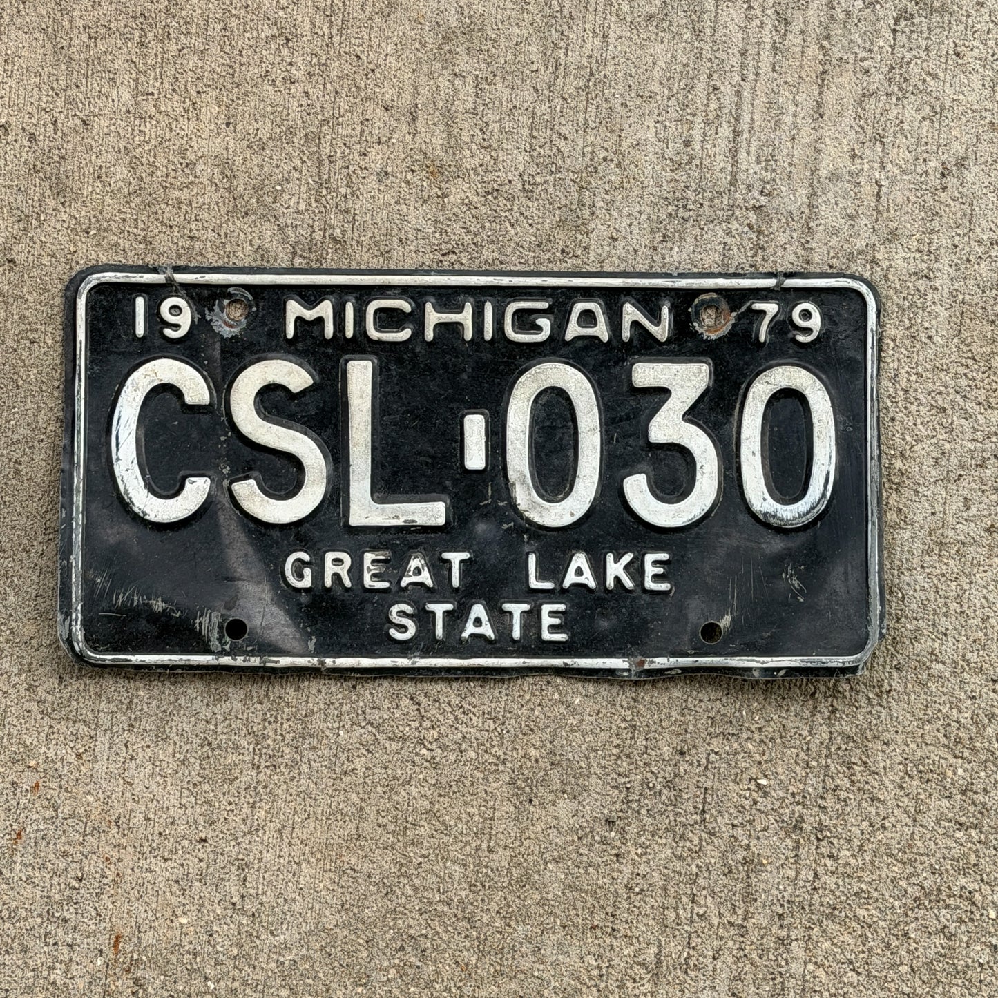 Photo of a 1979 Michigan License Plate Auto Tag Garage Decor Vintage CSL 030 with original patina